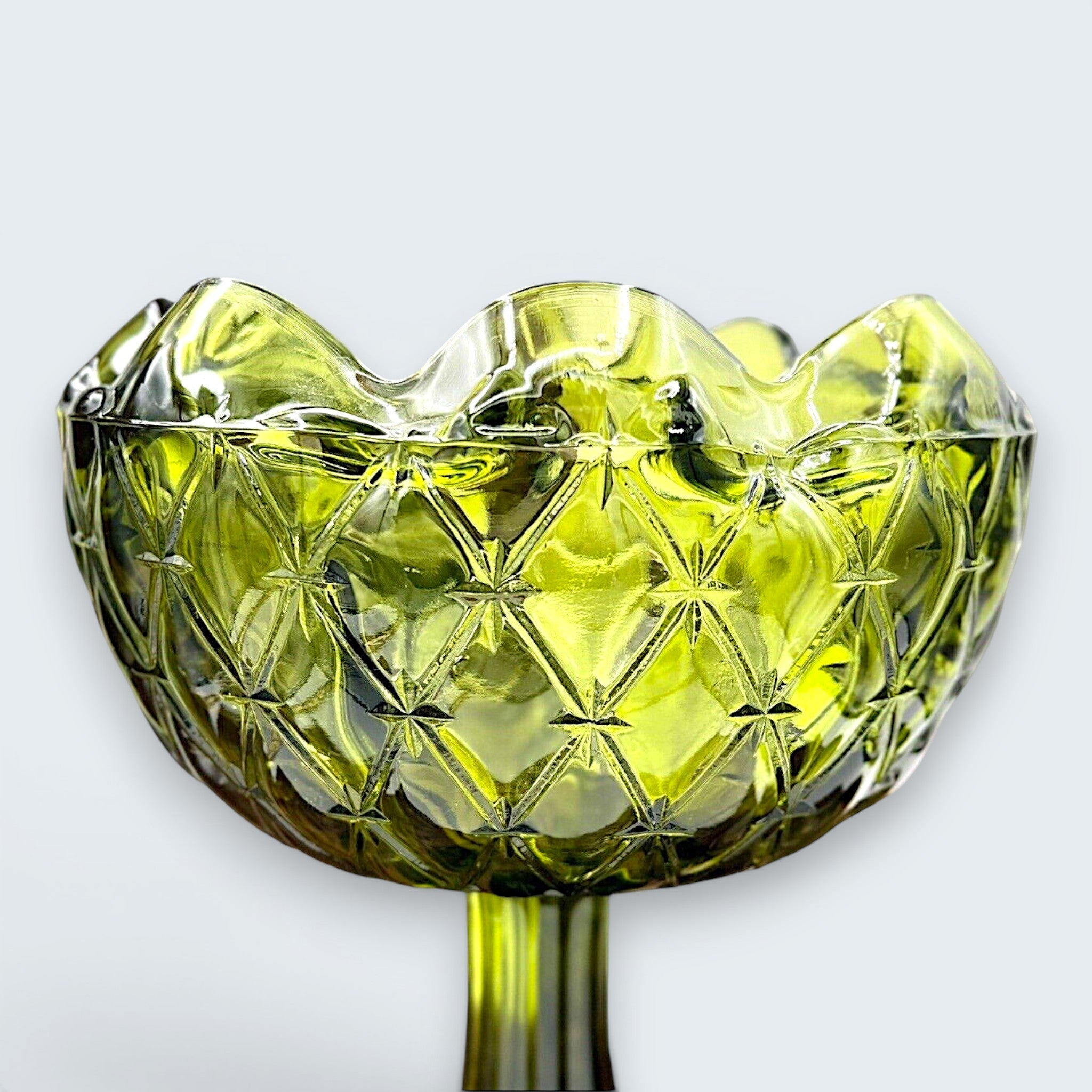 A vintage avocado green pressed glass compote bowl featuring a deeply textured diamond point pattern, a scalloped rim, and a tall, ribbed pedestal base. - Photo 2