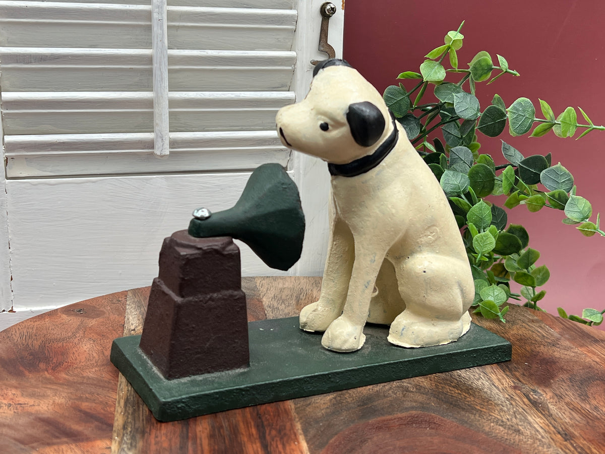 A heavy cast iron coin bank depicting the RCA Victor terrier dog sitting attentively next to a gramophone horn on a rectangular green painted base. - Photo 1