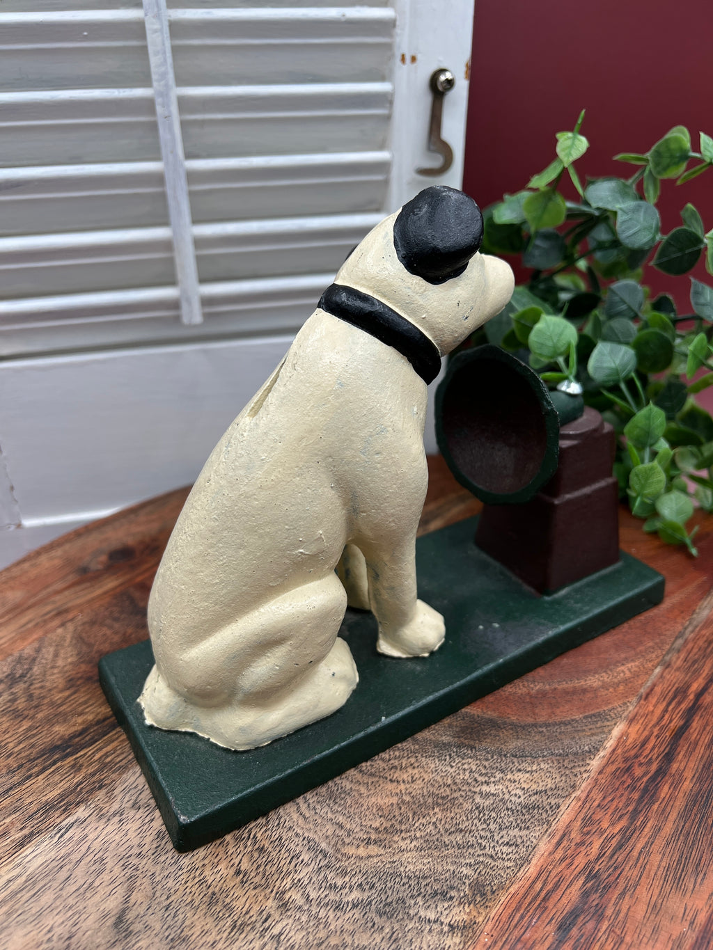 A heavy cast iron coin bank depicting the RCA Victor terrier dog sitting attentively next to a gramophone horn on a rectangular green painted base. - Photo 4