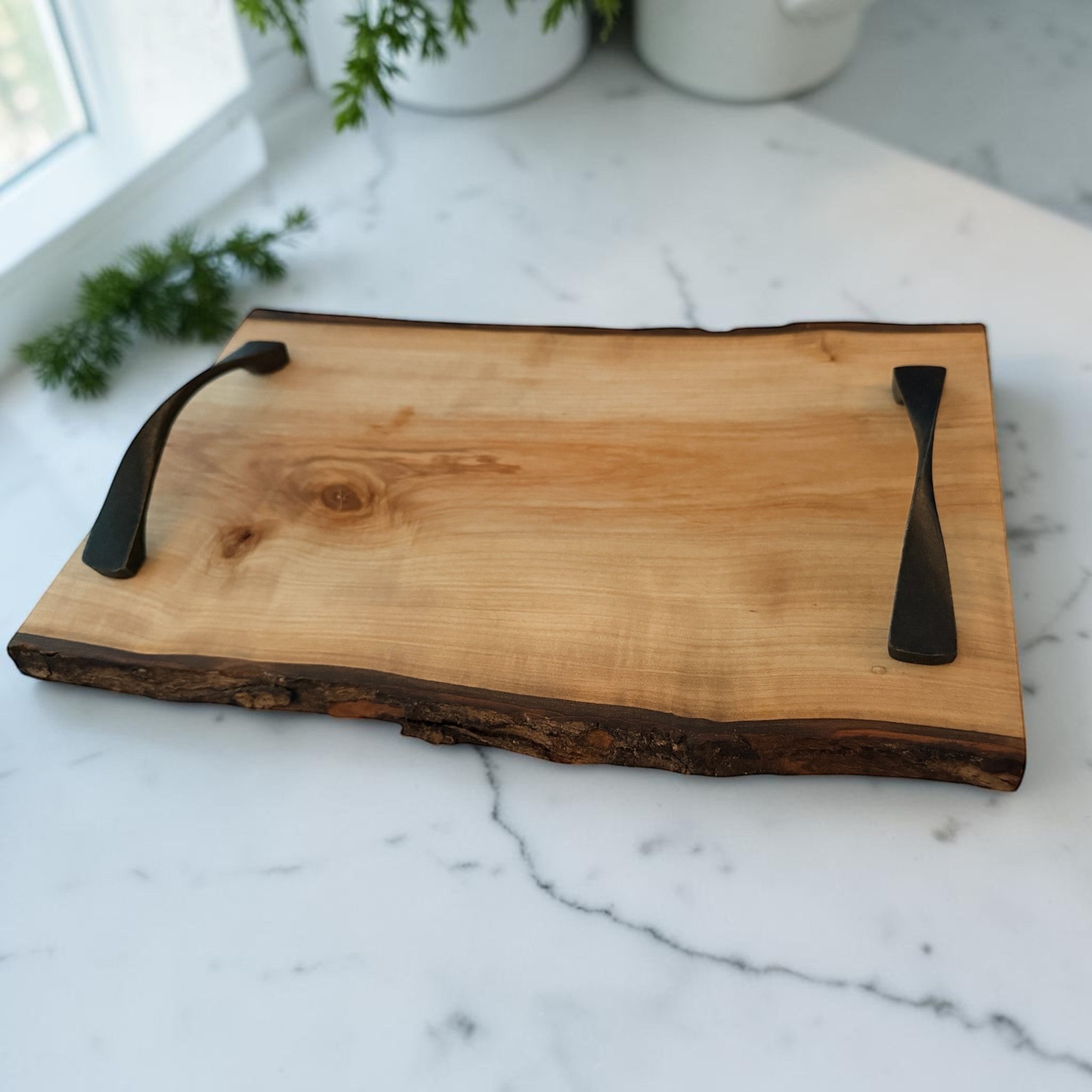 Patina & Prose live edge cherry wood serving tray with dark metal handles, 13.5-inch, natural bark edge, food-safe finish.