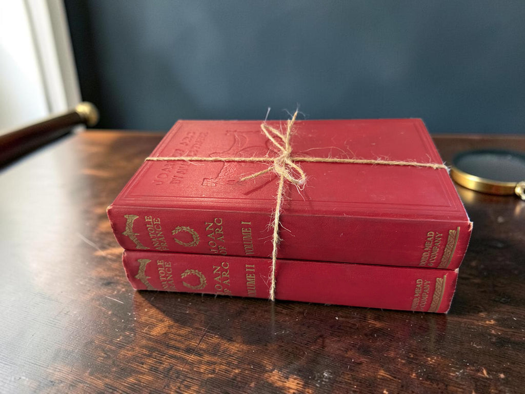 Patina & Prose: 1925 two-volume set of The Life of Joan of Arc by Anatole France, bound in crimson cloth with gold lettering.