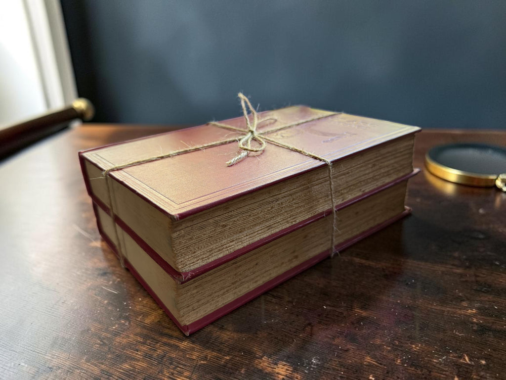 Patina & Prose 1925 two-volume set of The Life of Joan of Arc by Anatole France, bound in crimson cloth with gold-stamped spines and blind-stamped covers.
