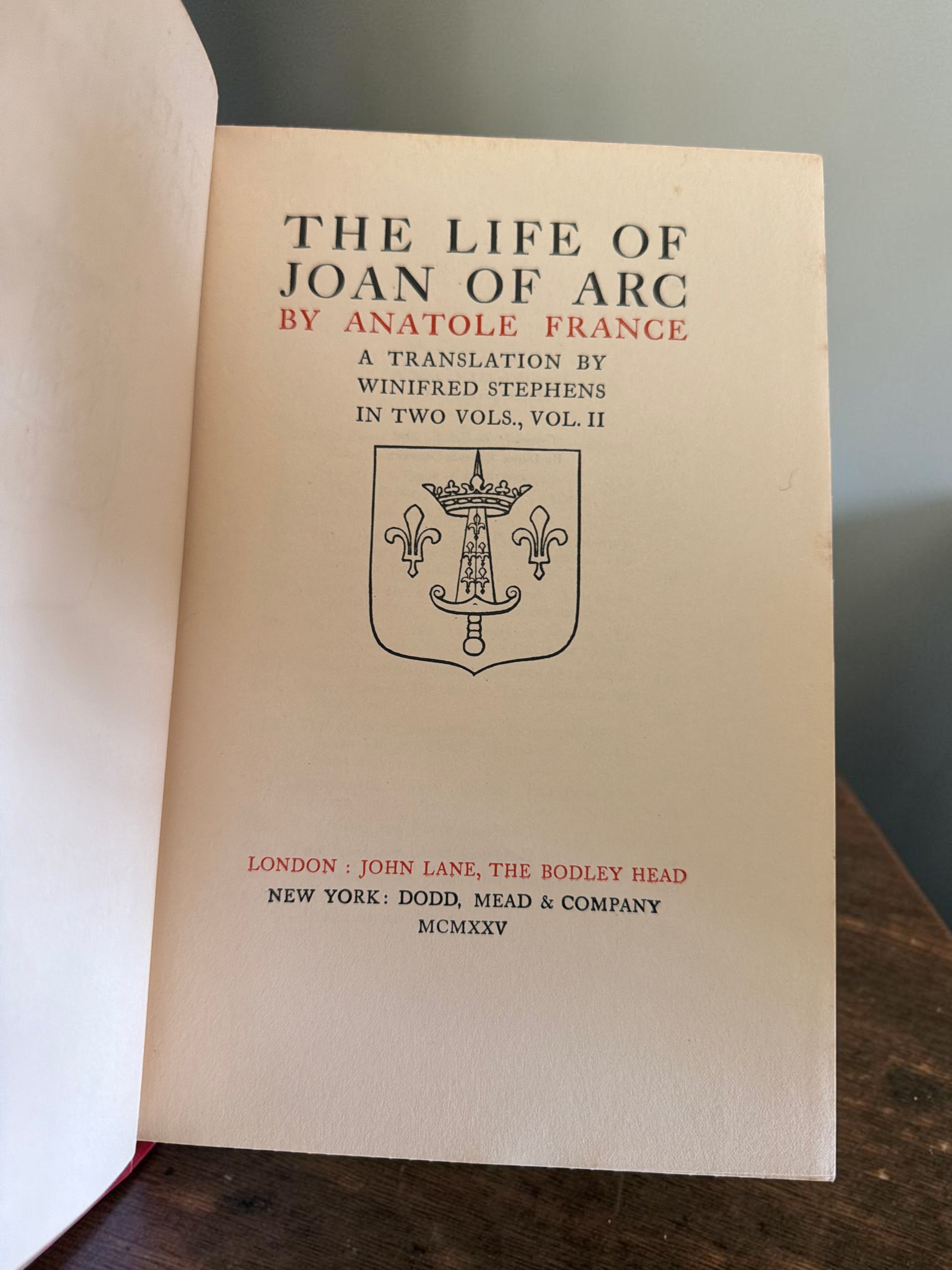 Patina & Prose 1925 two-volume set of The Life of Joan of Arc by Anatole France, bound in crimson cloth with gold-stamped spines.