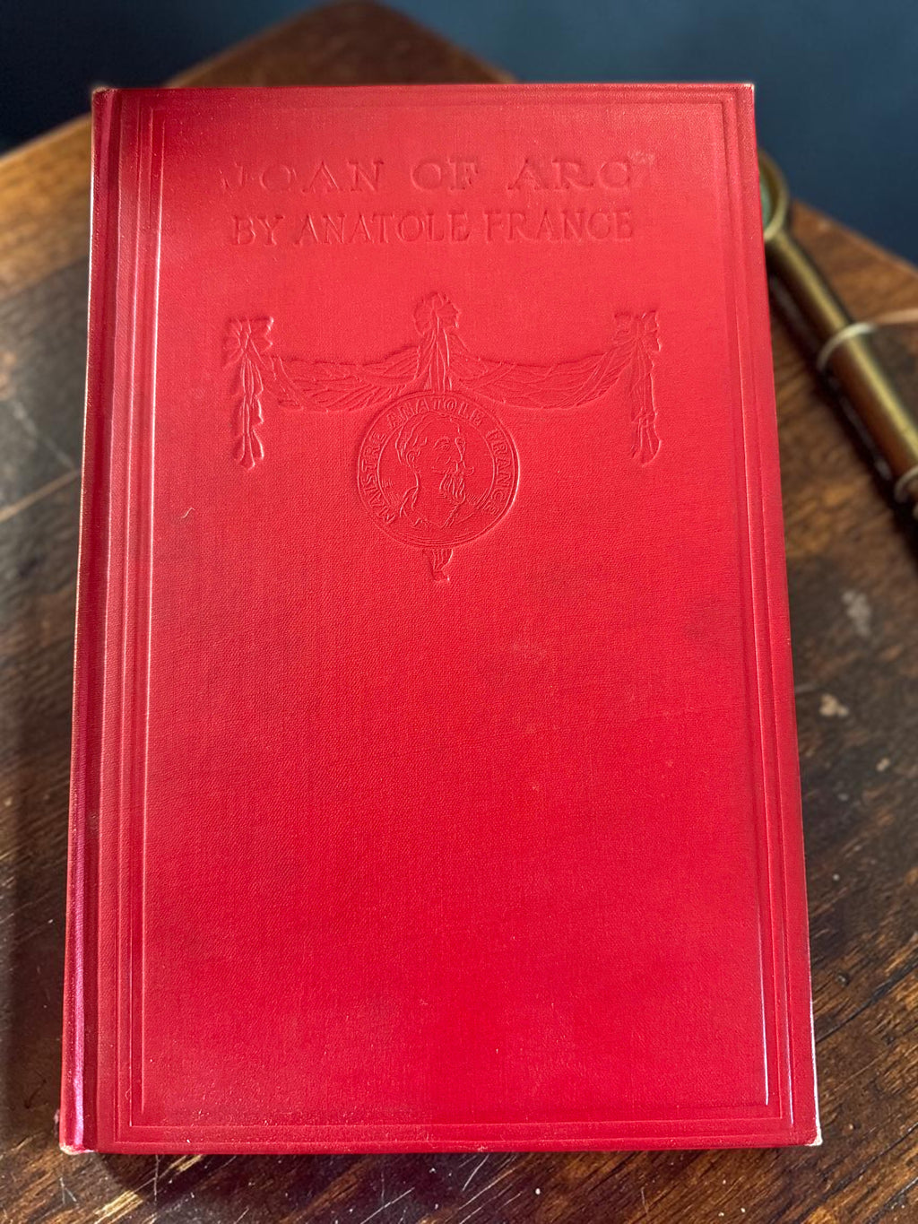 Patina & Prose 1925 two-volume set of The Life of Joan of Arc by Anatole France, bound in crimson cloth with blind-stamped titles and gold-stamped spines.