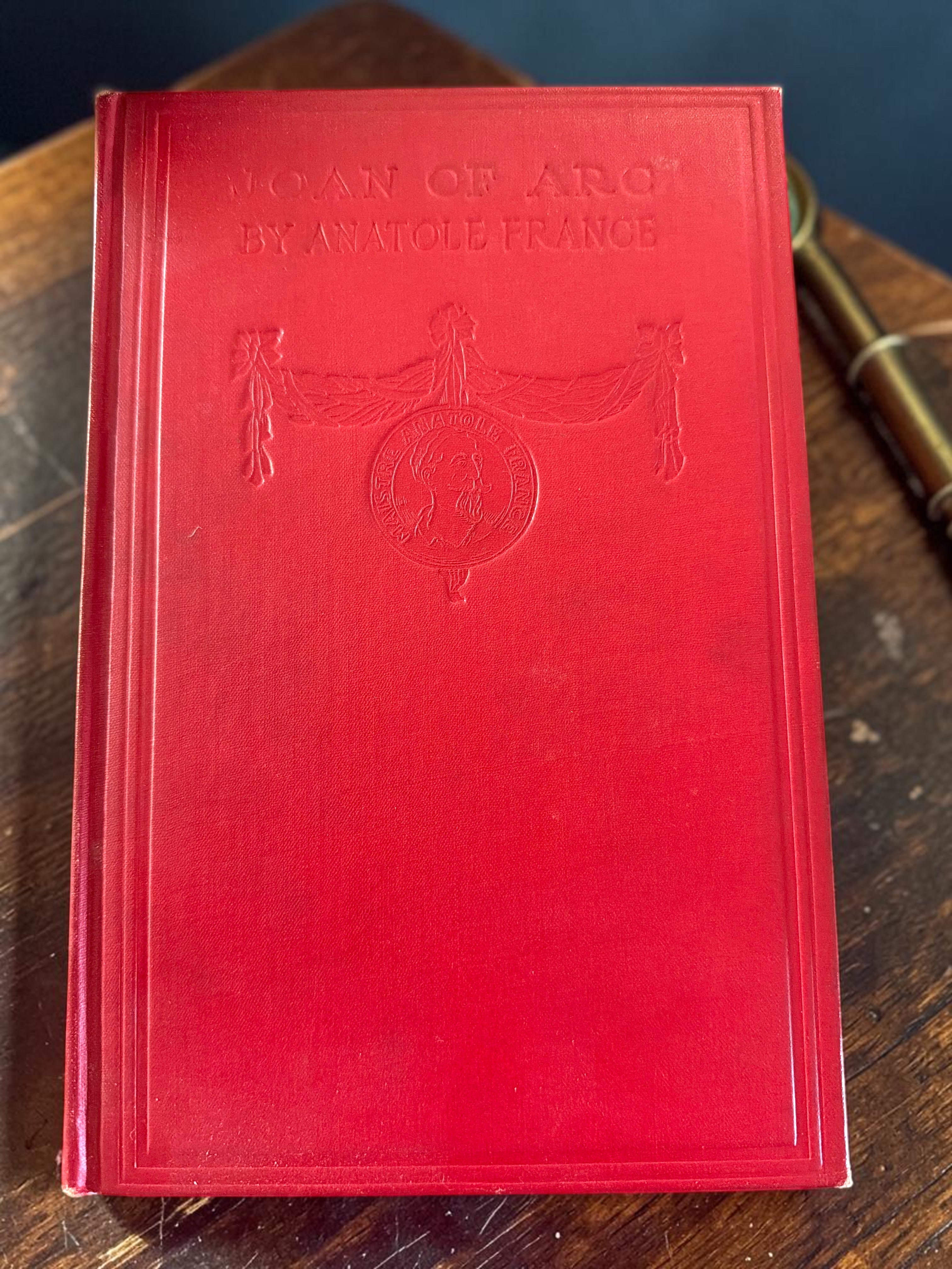 Patina & Prose 1925 two-volume set of The Life of Joan of Arc by Anatole France, bound in crimson cloth with blind-stamped titles and gold-stamped spines.