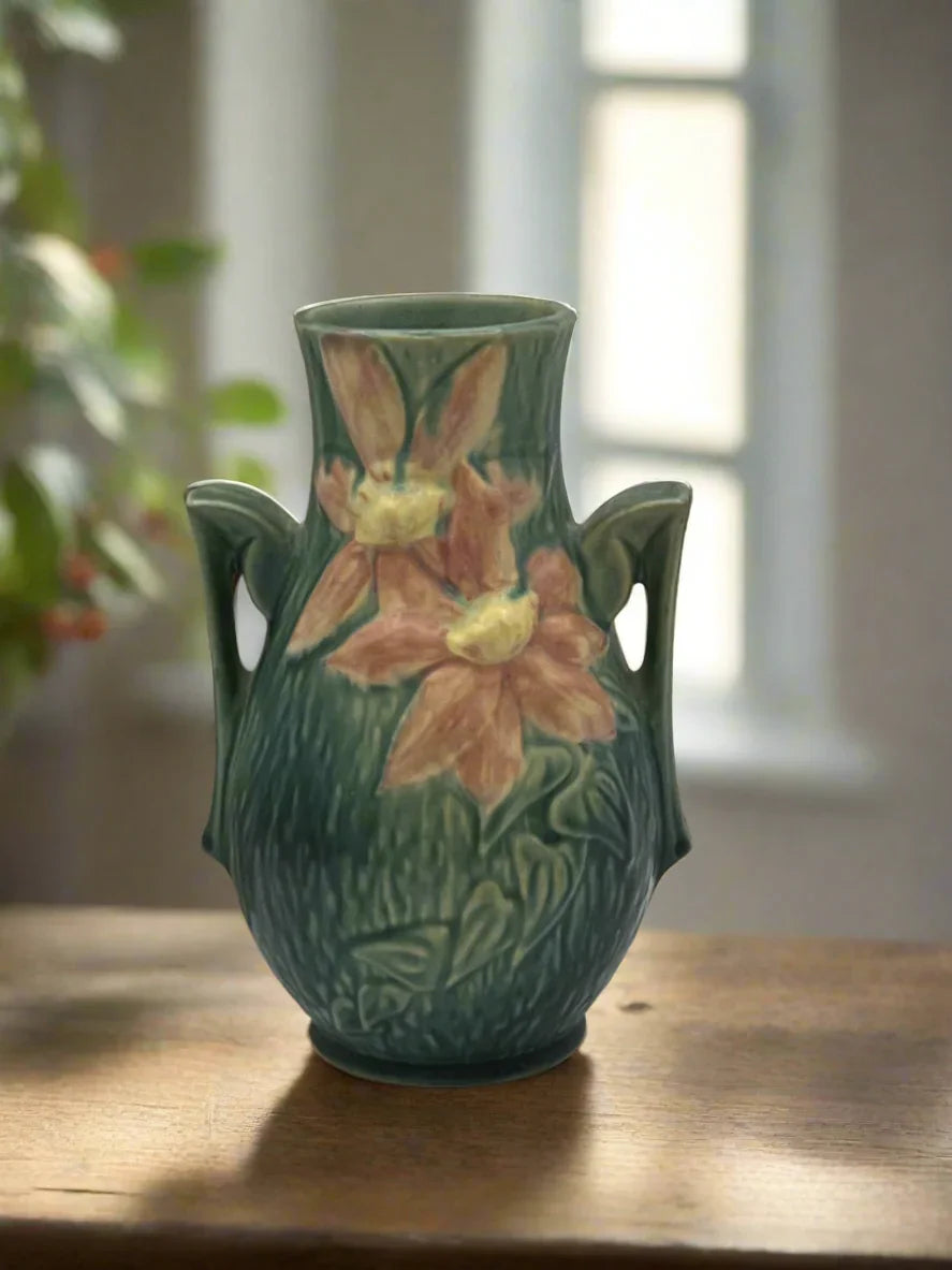 Vintage Roseville Clematis art pottery vase featuring an earthy green textured ground, sculpted angular side handles, and an embossed peach clematis bloom with a yellow center. - Photo 2