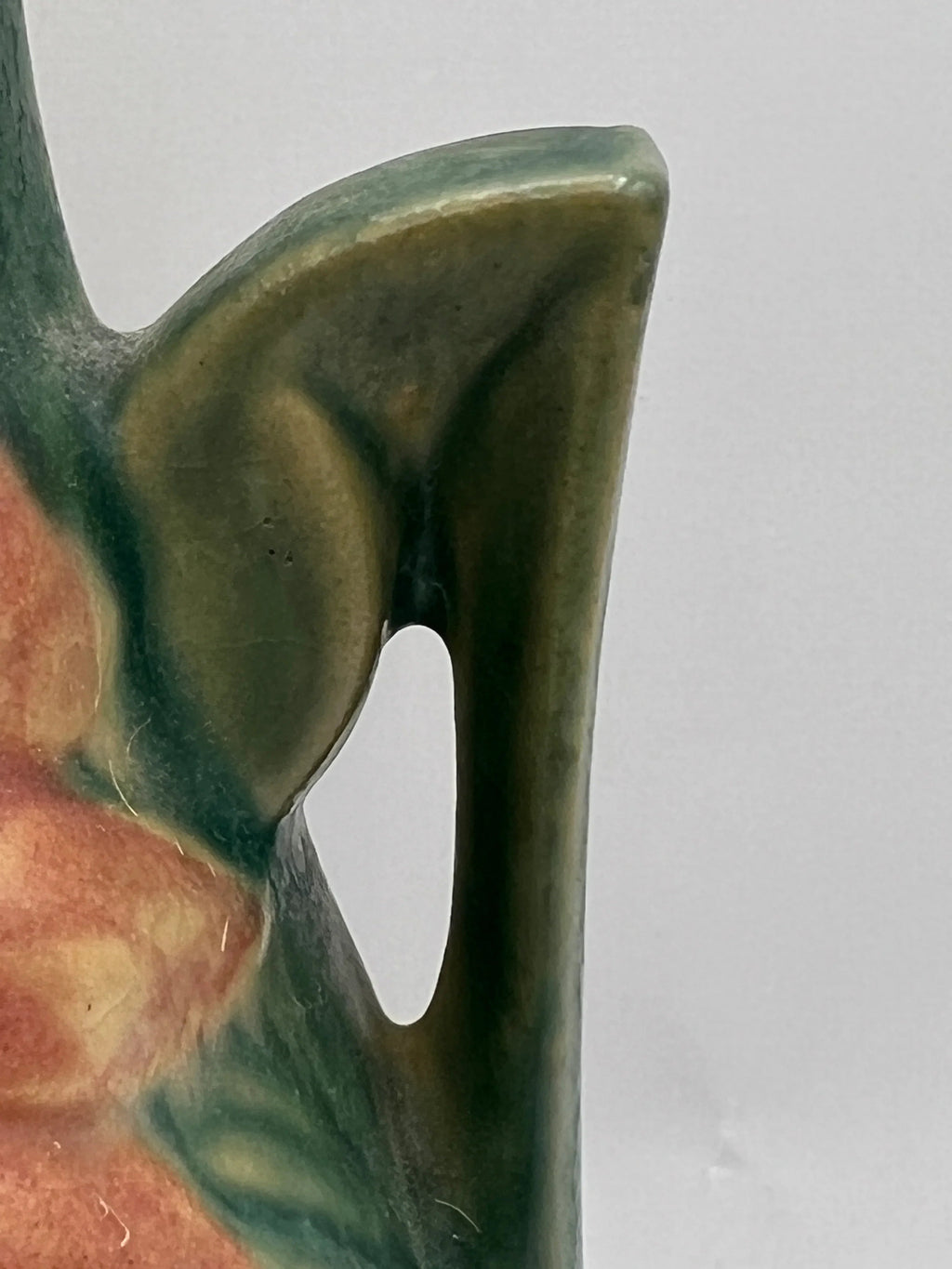Vintage Roseville Clematis art pottery vase featuring an earthy green textured ground, sculpted angular side handles, and an embossed peach clematis bloom with a yellow center. - Photo 4