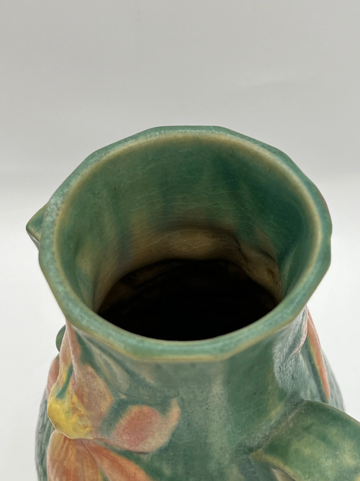Vintage Roseville Clematis art pottery vase featuring an earthy green textured ground, sculpted angular side handles, and an embossed peach clematis bloom with a yellow center. - Photo 6