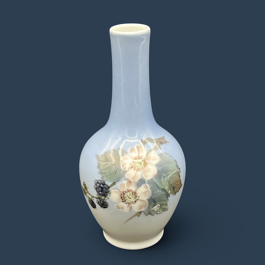 A Royal Copenhagen porcelain bud vase featuring a bulbous body, a slender elongated neck, and a glossy white glaze that fades into a soft cream and pale blue-gray gradient at the base. - Photo 1