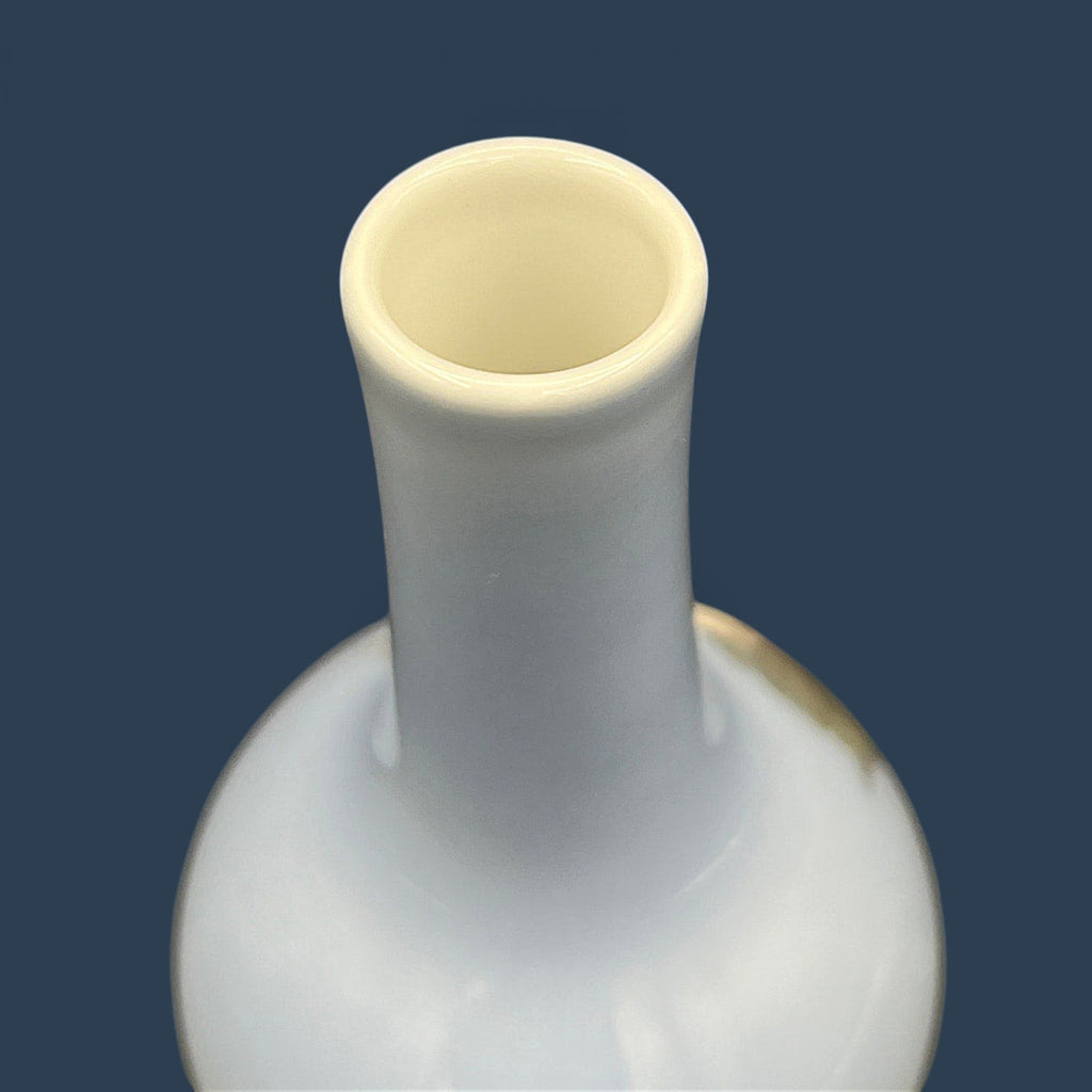 A Royal Copenhagen porcelain bud vase featuring a bulbous body, a slender elongated neck, and a glossy white glaze that fades into a soft cream and pale blue-gray gradient at the base. - Photo 4