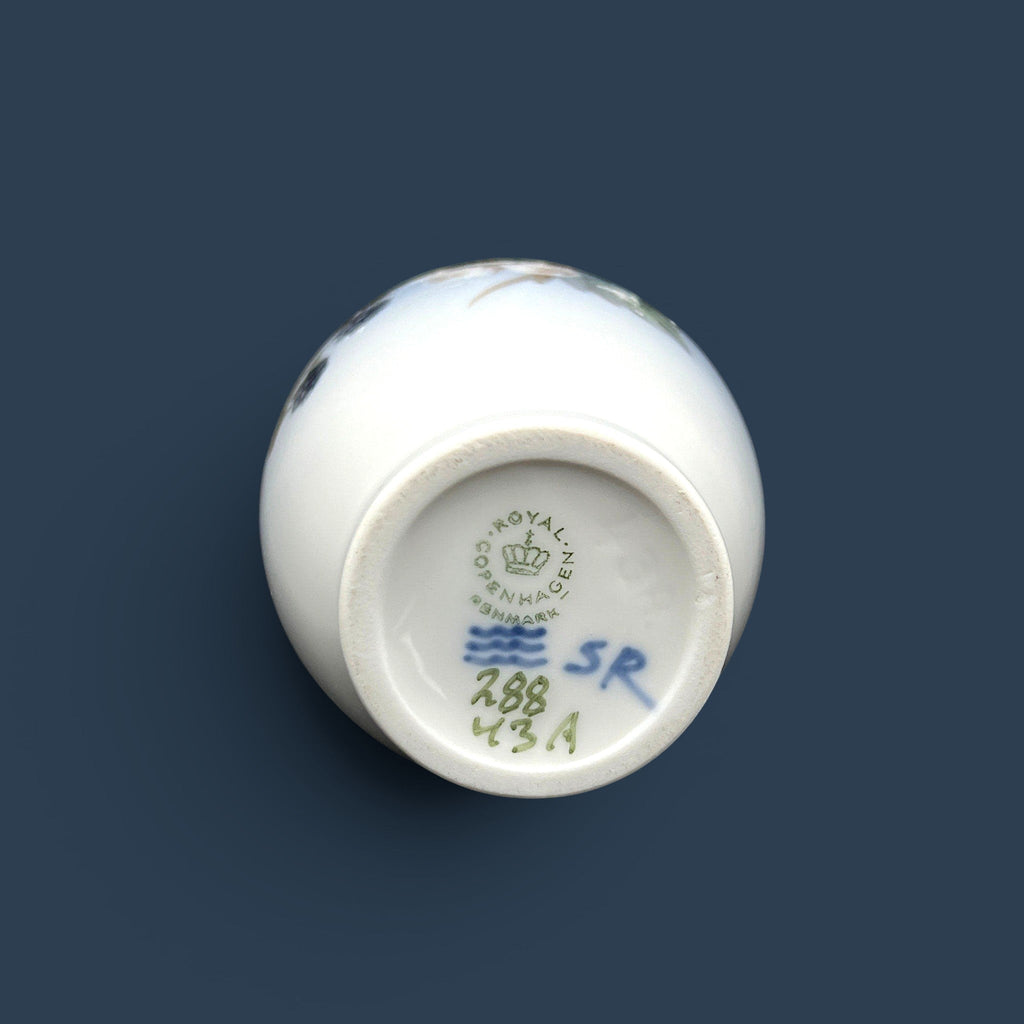 A Royal Copenhagen porcelain bud vase featuring a bulbous body, a slender elongated neck, and a glossy white glaze that fades into a soft cream and pale blue-gray gradient at the base. - Photo 5