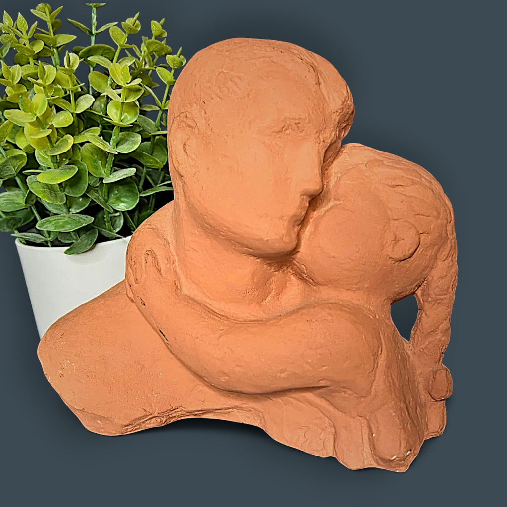Terracotta clay sculpture depicting two stylized human figures held in a warm close embrace with a hand-modeled rough tactile surface. - Photo 2