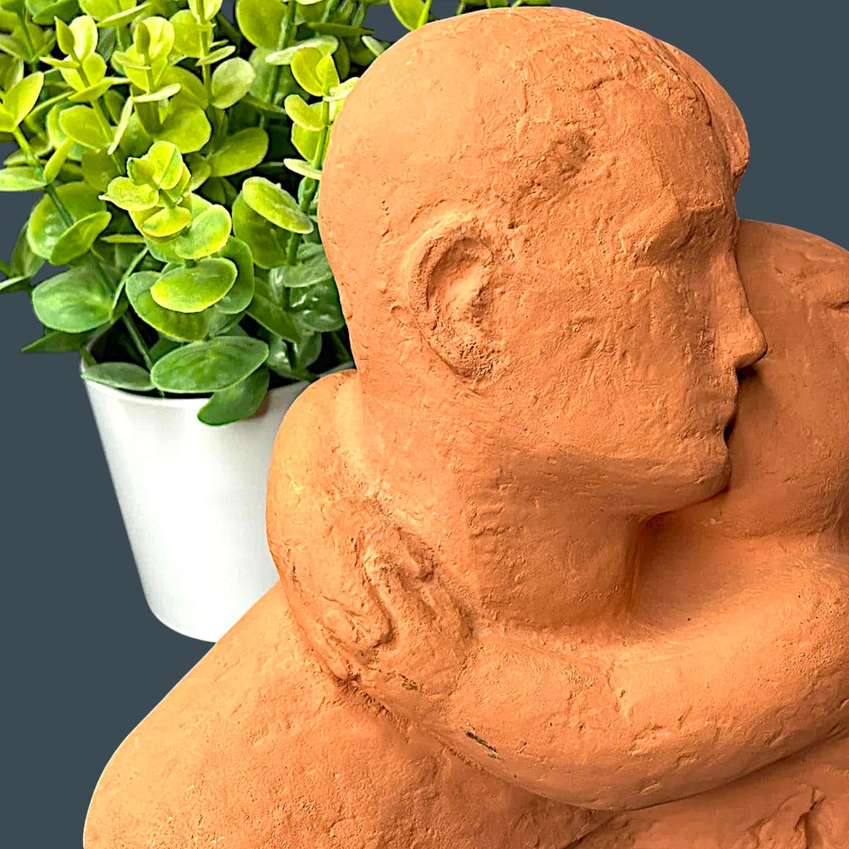Terracotta clay sculpture depicting two stylized human figures held in a warm close embrace with a hand-modeled rough tactile surface. - Photo 7