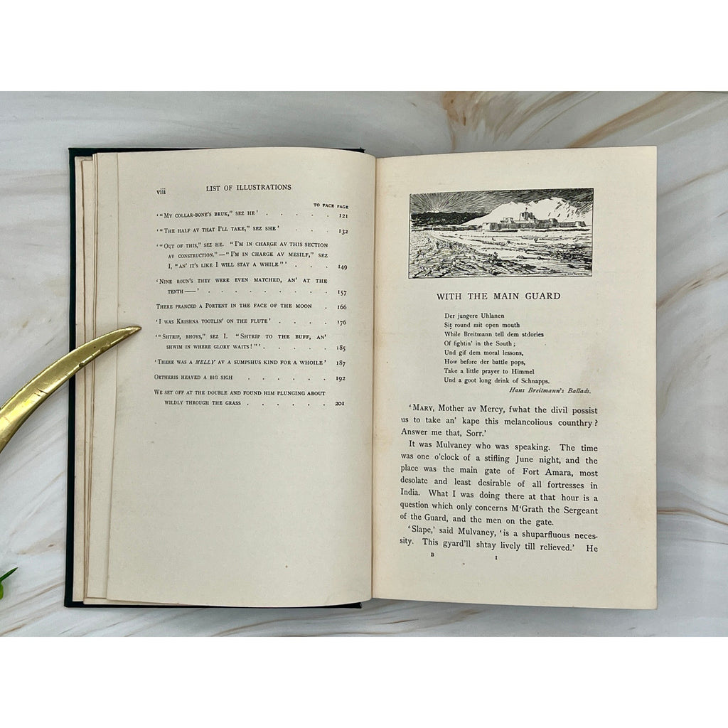 Antique Kipling Soldier Stories (1897) hardcover with gilt soldiers and exotic wildlife; open pages show illustrations.