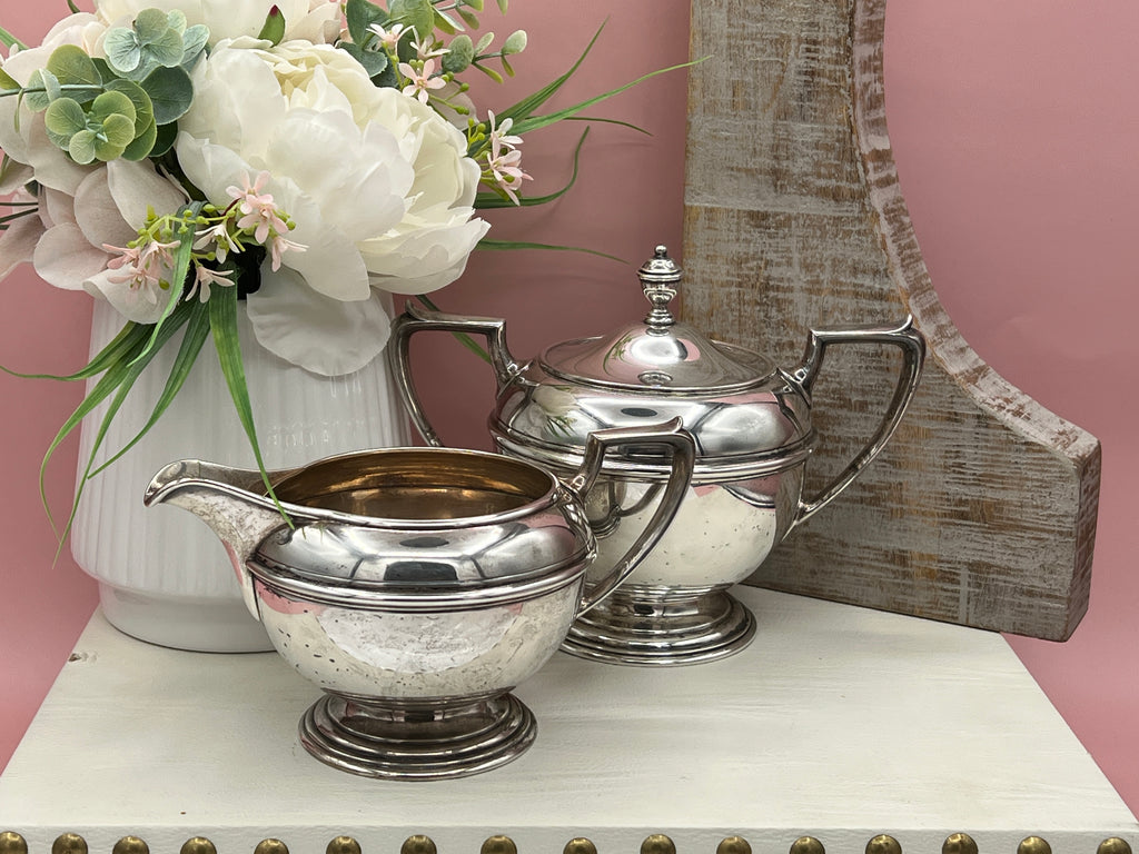 Antique William B. Durgin sterling silver two-handled covered sugar bowl with a polished urn-shaped body, stepped pedestal base, and matching domed lid topped with an urn finial displayed on a white tabletop. - Photo 4