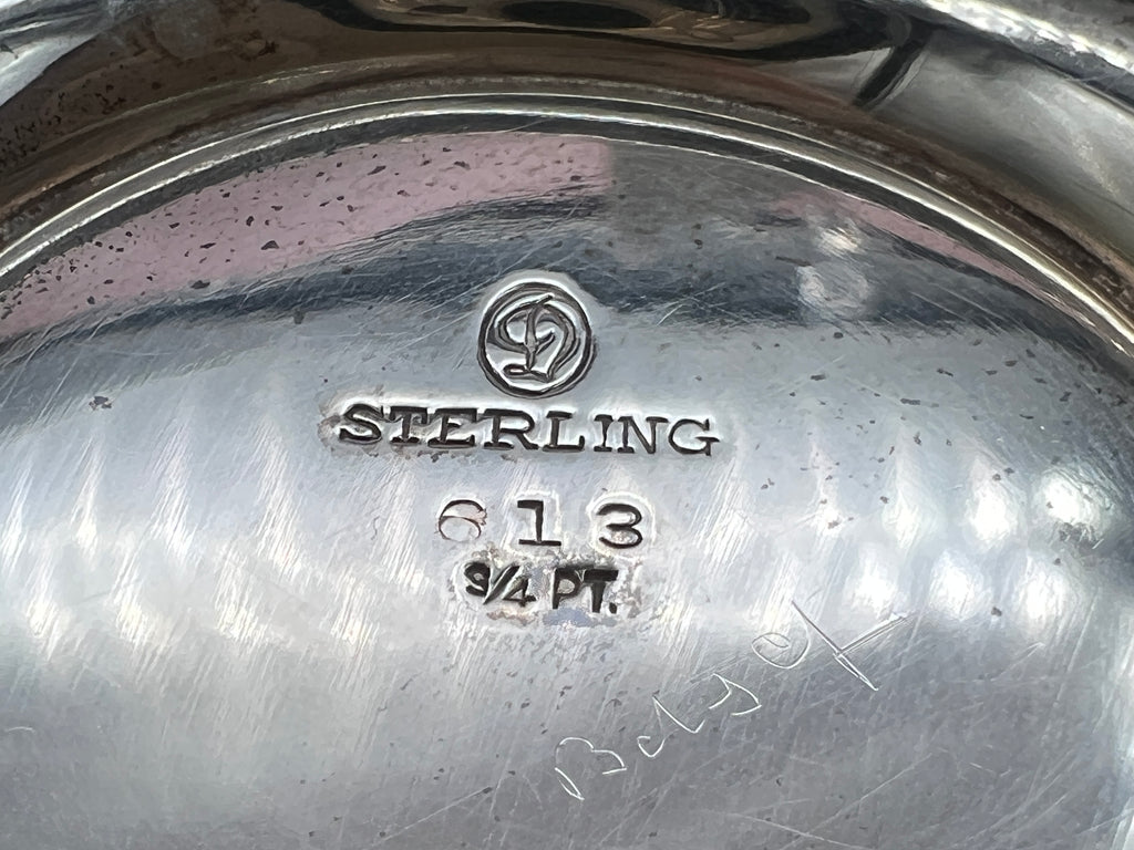 Antique William B. Durgin sterling silver two-handled covered sugar bowl with a polished urn-shaped body, stepped pedestal base, and matching domed lid topped with an urn finial displayed on a white tabletop. - Photo 10