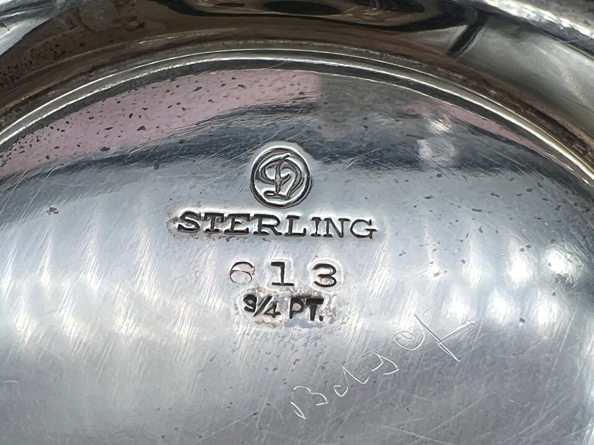 Antique William B. Durgin sterling silver two-handled covered sugar bowl with a polished urn-shaped body, stepped pedestal base, and matching domed lid topped with an urn finial displayed on a white tabletop. - Photo 10