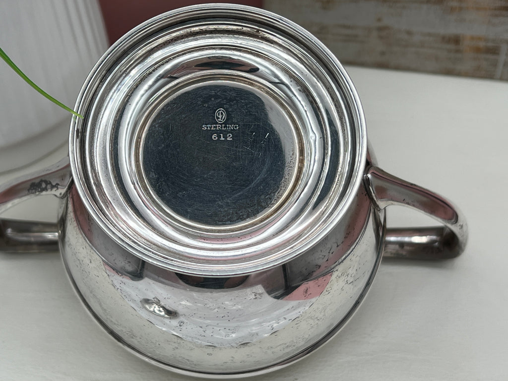 Antique William B. Durgin sterling silver two-handled covered sugar bowl with a polished urn-shaped body, stepped pedestal base, and matching domed lid topped with an urn finial displayed on a white tabletop. - Photo 14