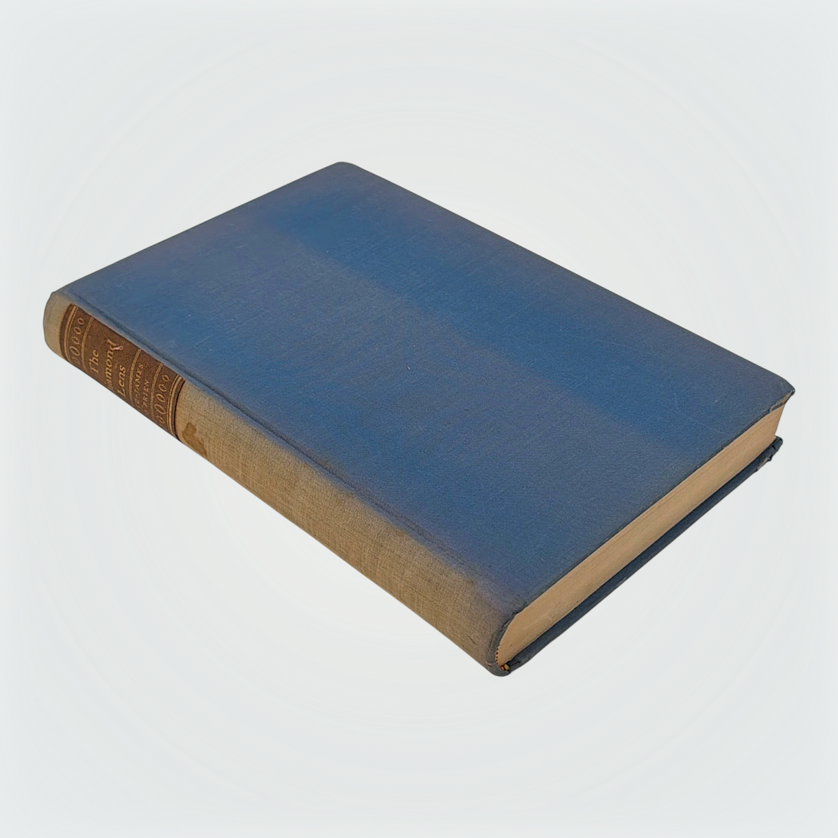 Open hardcover volume of The Diamond Lens and Other Stories displaying the printed colophon leaf set in Estienne type on cream paper with dark blue cloth covers. - Photo 1