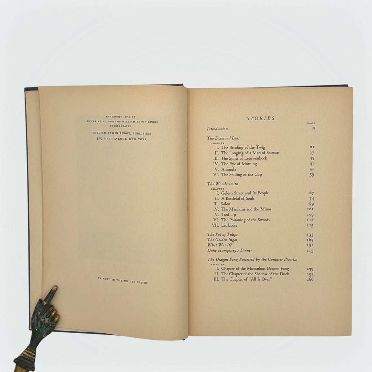 Open hardcover volume of The Diamond Lens and Other Stories displaying the printed colophon leaf set in Estienne type on cream paper with dark blue cloth covers. - Photo 4