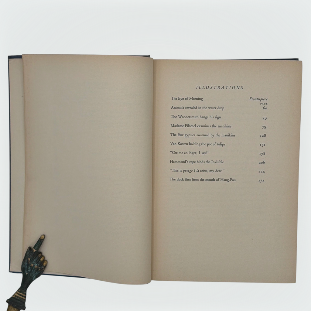 Open hardcover volume of The Diamond Lens and Other Stories displaying the printed colophon leaf set in Estienne type on cream paper with dark blue cloth covers. - Photo 5