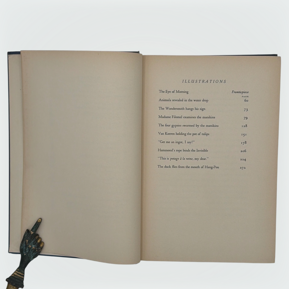 Open hardcover volume of The Diamond Lens and Other Stories displaying the printed colophon leaf set in Estienne type on cream paper with dark blue cloth covers. - Photo 5