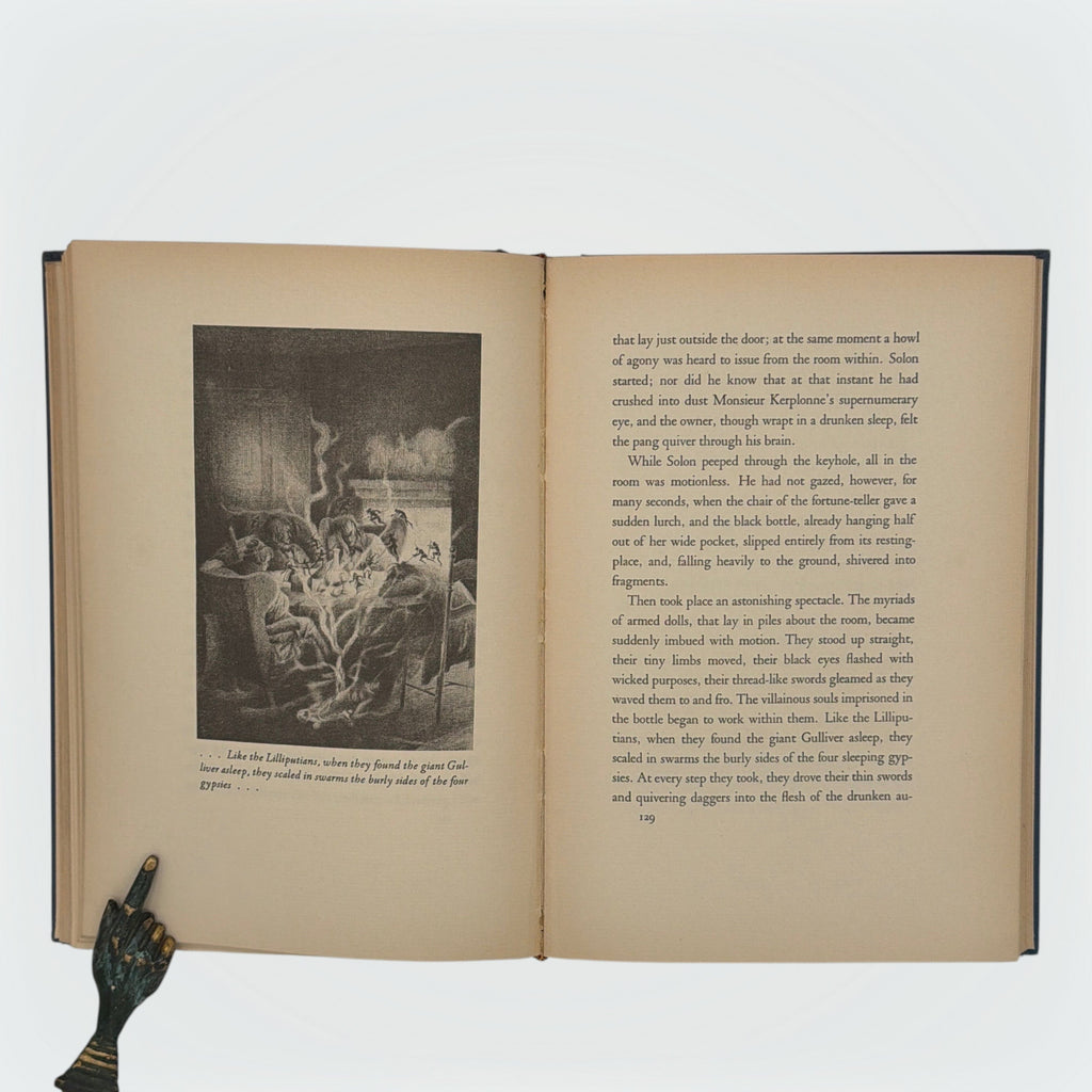 Open hardcover volume of The Diamond Lens and Other Stories displaying the printed colophon leaf set in Estienne type on cream paper with dark blue cloth covers. - Photo 6