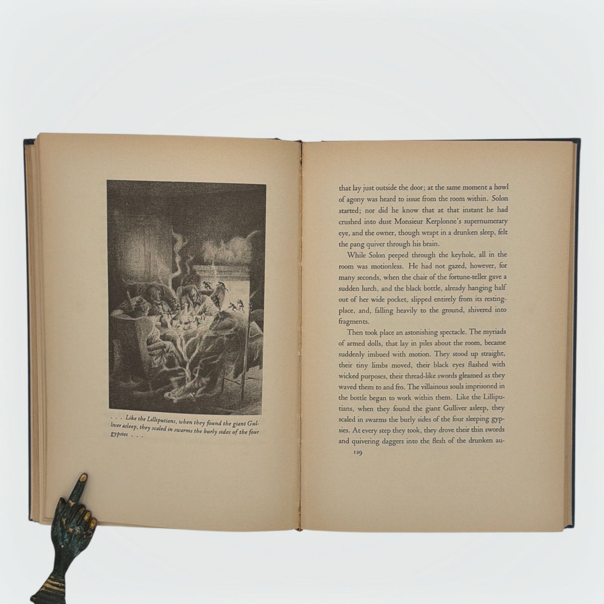 Open hardcover volume of The Diamond Lens and Other Stories displaying the printed colophon leaf set in Estienne type on cream paper with dark blue cloth covers. - Photo 6