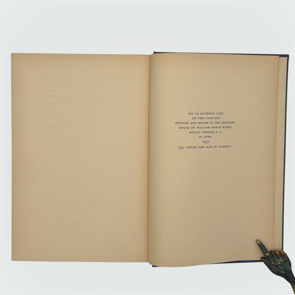 Open hardcover volume of The Diamond Lens and Other Stories displaying the printed colophon leaf set in Estienne type on cream paper with dark blue cloth covers. - Photo 7