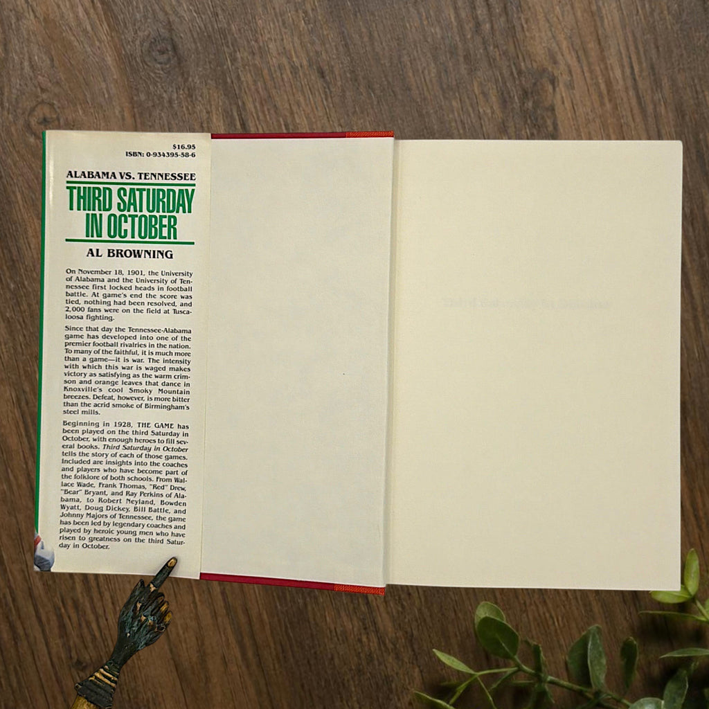 Hardcover book titled Third Saturday in October featuring a green dust jacket with bold white lettering and a full-color action illustration of Alabama and Tennessee football players in mid-tackle. - Photo 3