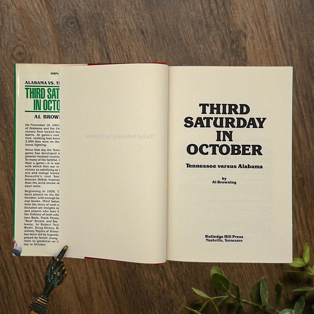Hardcover book titled Third Saturday in October featuring a green dust jacket with bold white lettering and a full-color action illustration of Alabama and Tennessee football players in mid-tackle. - Photo 4