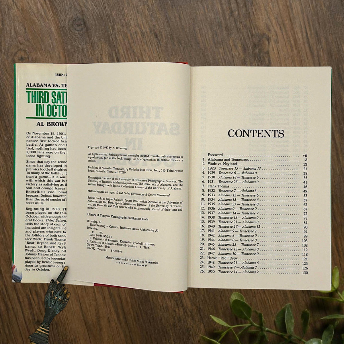 Hardcover book titled Third Saturday in October featuring a green dust jacket with bold white lettering and a full-color action illustration of Alabama and Tennessee football players in mid-tackle. - Photo 5