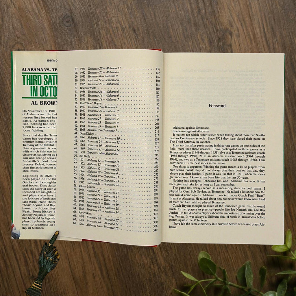 Hardcover book titled Third Saturday in October featuring a green dust jacket with bold white lettering and a full-color action illustration of Alabama and Tennessee football players in mid-tackle. - Photo 6
