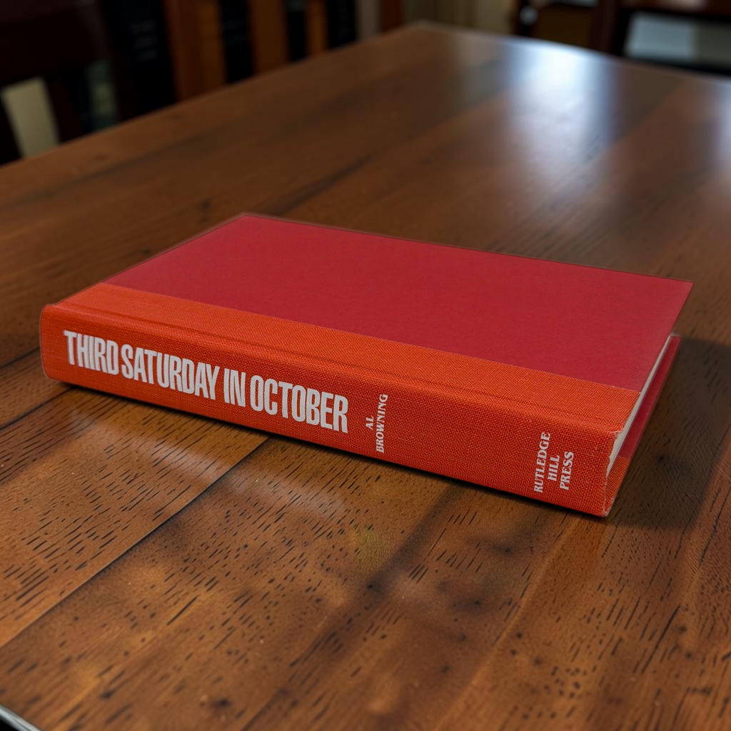 Hardcover book titled Third Saturday in October featuring a green dust jacket with bold white lettering and a full-color action illustration of Alabama and Tennessee football players in mid-tackle. - Photo 9