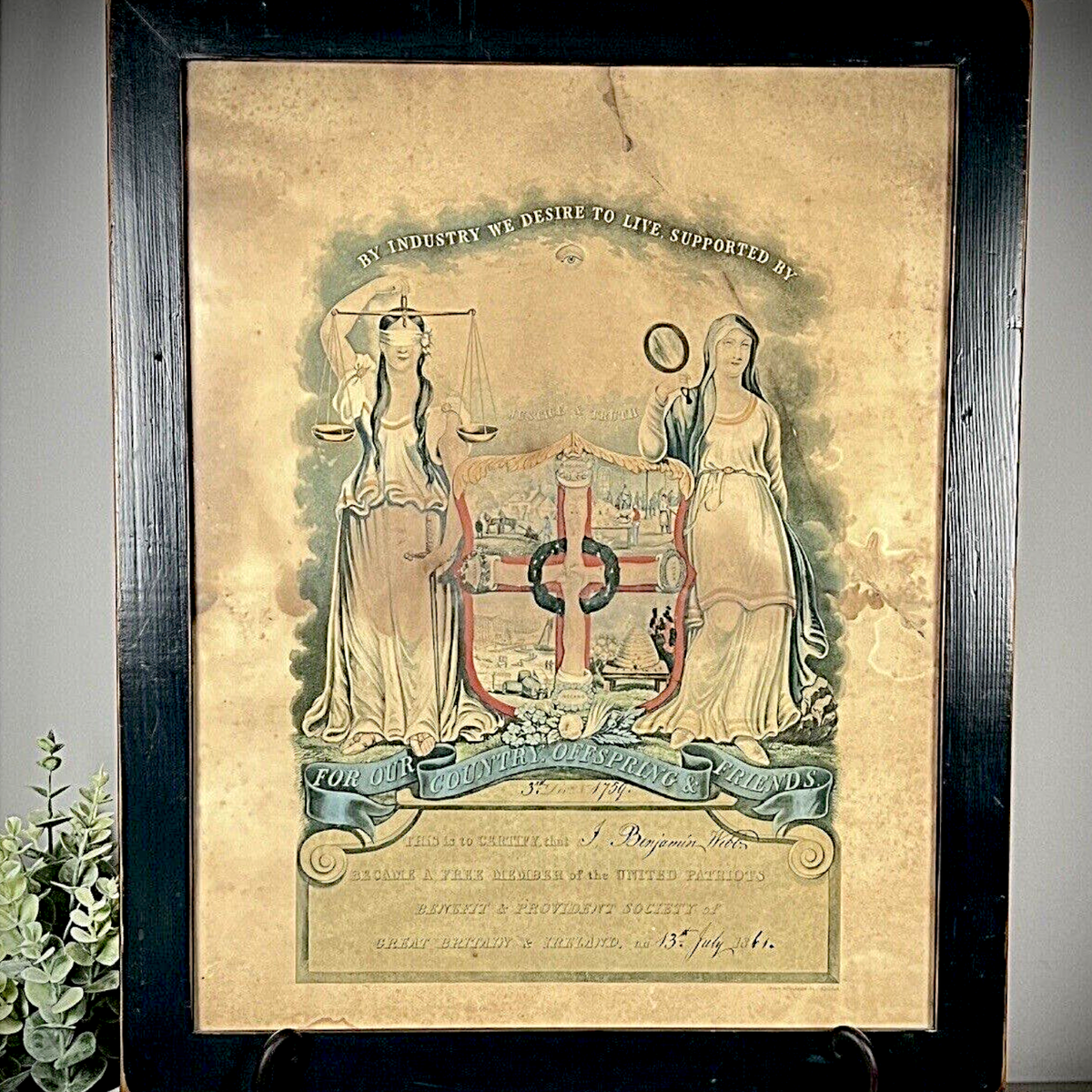 Framed 1861 Victorian United Patriots Benefit and Provident Society membership certificate print featuring allegorical figures of Justice and Truth flanking an industrial coat of arms in a dark rustic wood frame. - Photo 1