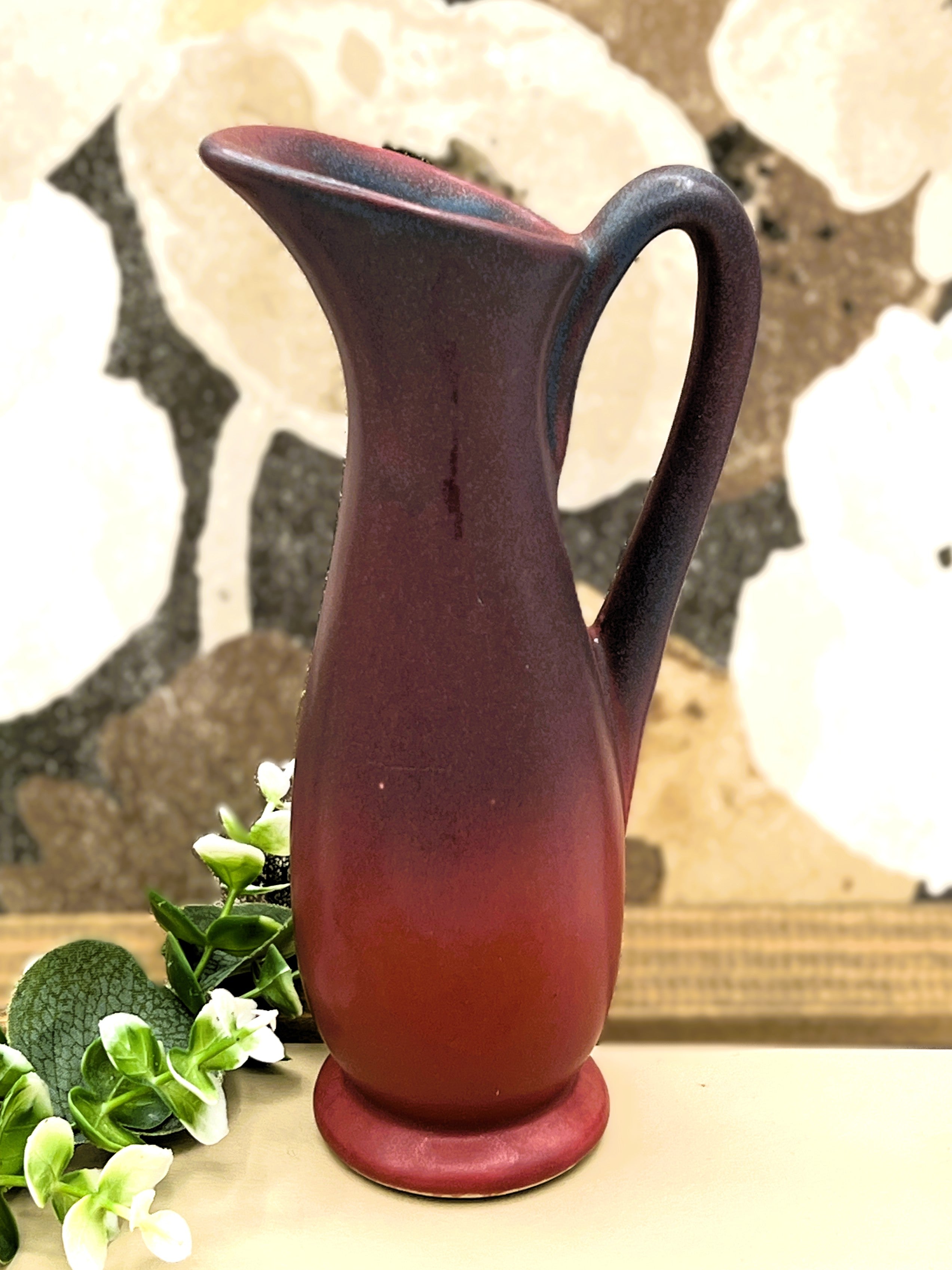 A vintage Van Briggle ceramic pitcher featuring a deep mulberry matte glaze with soft blue-tinted highlights along the pinched spout and sculpted arched handle. - Photo 2