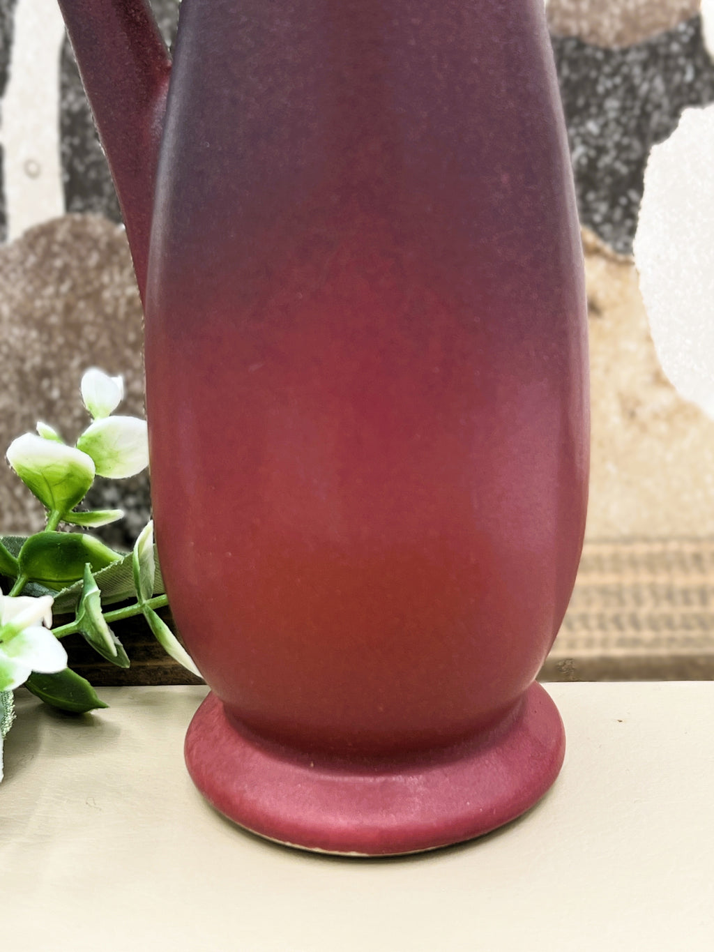 A vintage Van Briggle ceramic pitcher featuring a deep mulberry matte glaze with soft blue-tinted highlights along the pinched spout and sculpted arched handle. - Photo 3