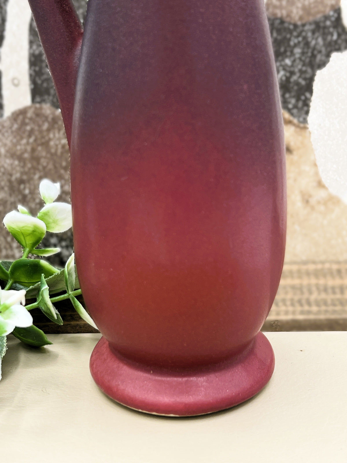 A vintage Van Briggle ceramic pitcher featuring a deep mulberry matte glaze with soft blue-tinted highlights along the pinched spout and sculpted arched handle. - Photo 3