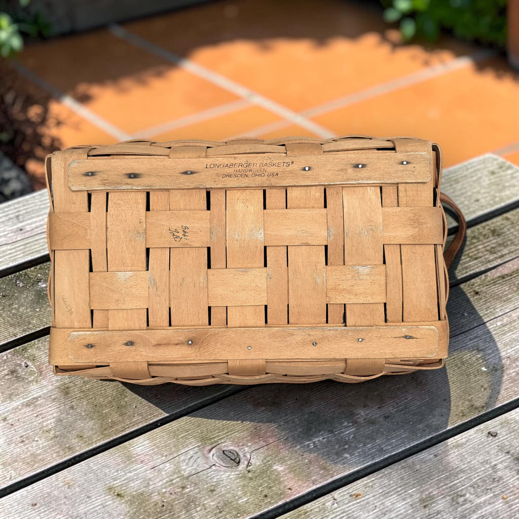 A rectangular 1998 Longaberger handwoven wood splint basket with brown leather handles. - Photo 3