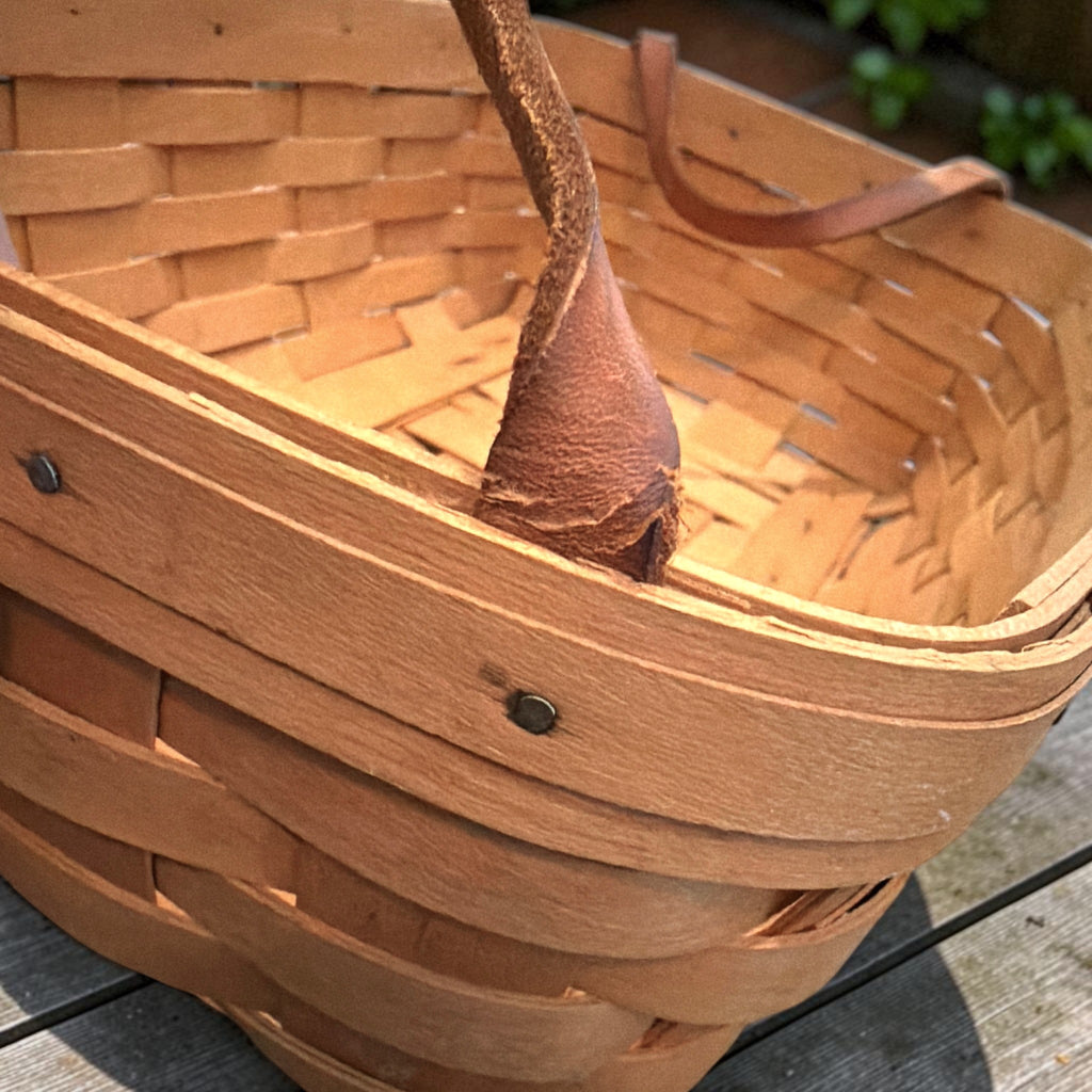 A rectangular 1998 Longaberger handwoven wood splint basket with brown leather handles. - Photo 4