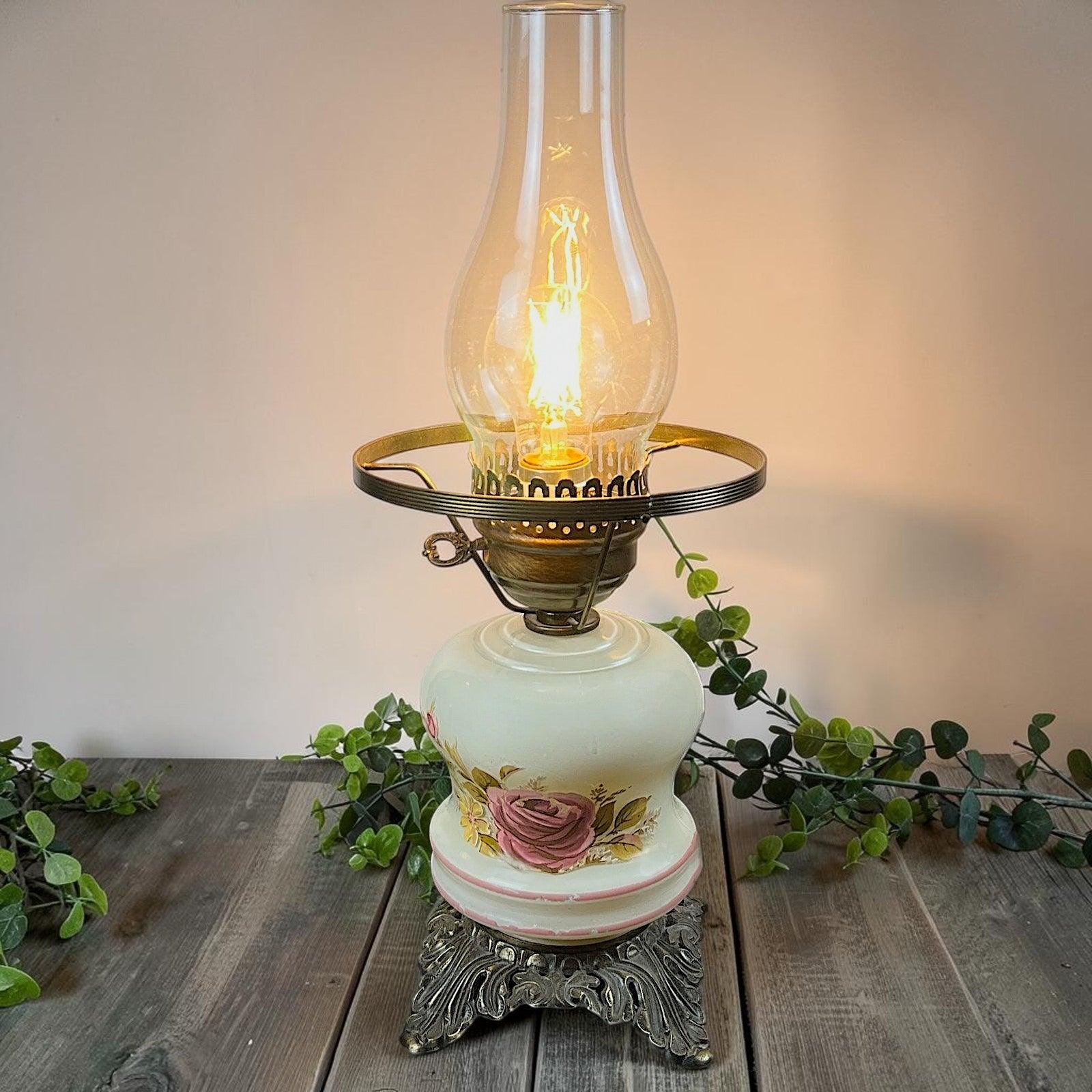A vintage milk glass hurricane parlor lamp base with hand-painted pink stripes and a highly detailed, ornate brass-finish cast metal footed base. - Photo 1
