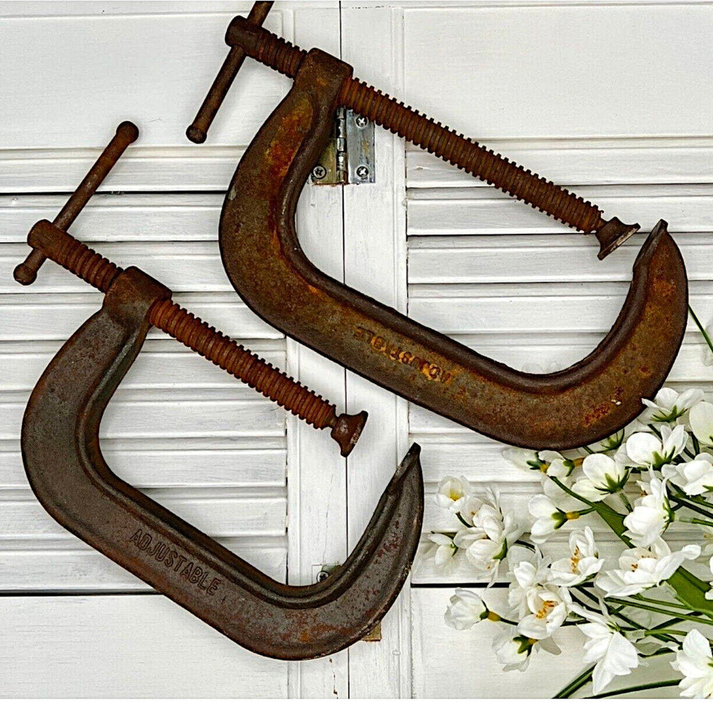 A pair of vintage industrial cast iron C-clamps by the Adjustable Clamp Co. displaying a rich rust brown patina on their heavy frames and steel screws. - Photo 3