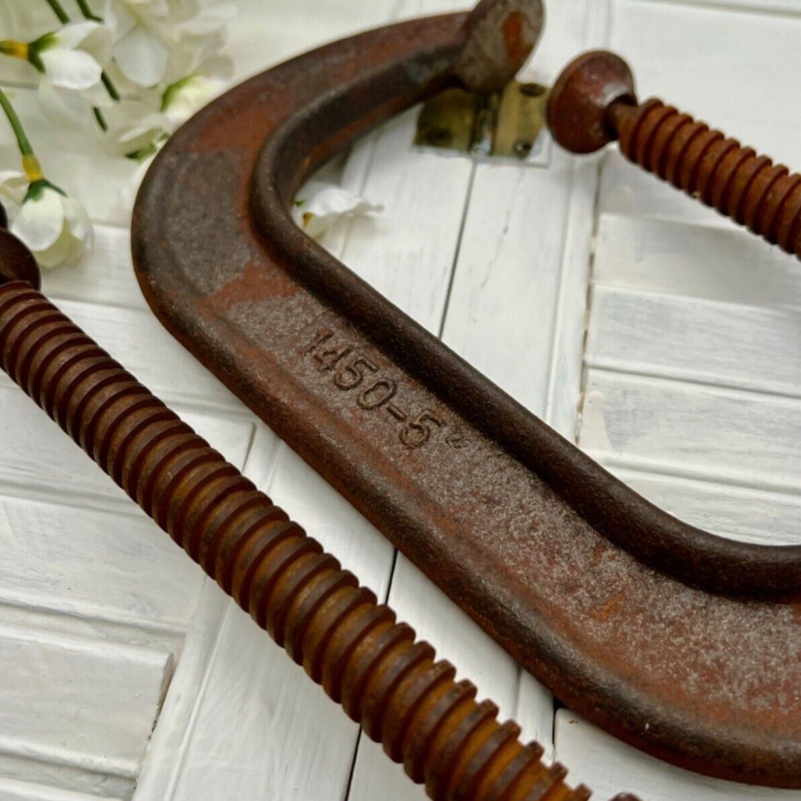 A pair of vintage industrial cast iron C-clamps by the Adjustable Clamp Co. displaying a rich rust brown patina on their heavy frames and steel screws. - Photo 4