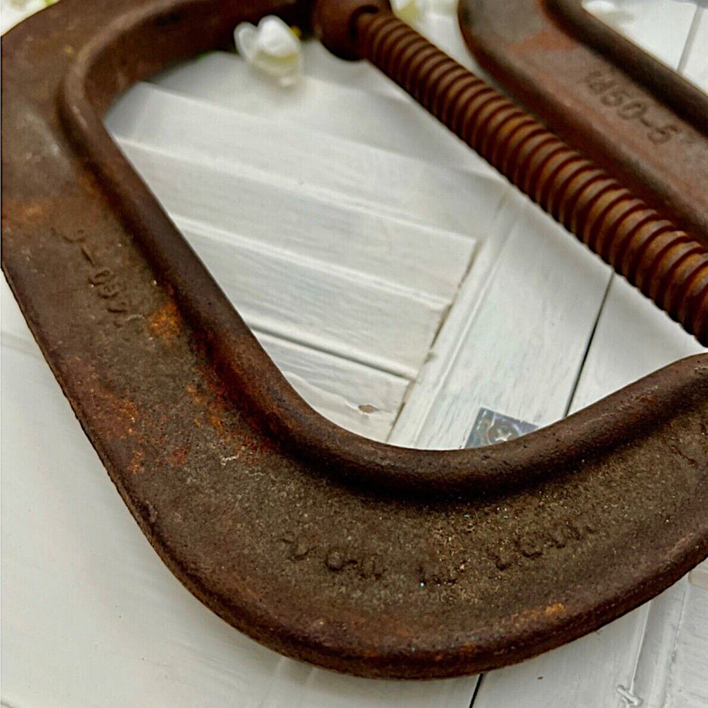 A pair of vintage industrial cast iron C-clamps by the Adjustable Clamp Co. displaying a rich rust brown patina on their heavy frames and steel screws. - Photo 5