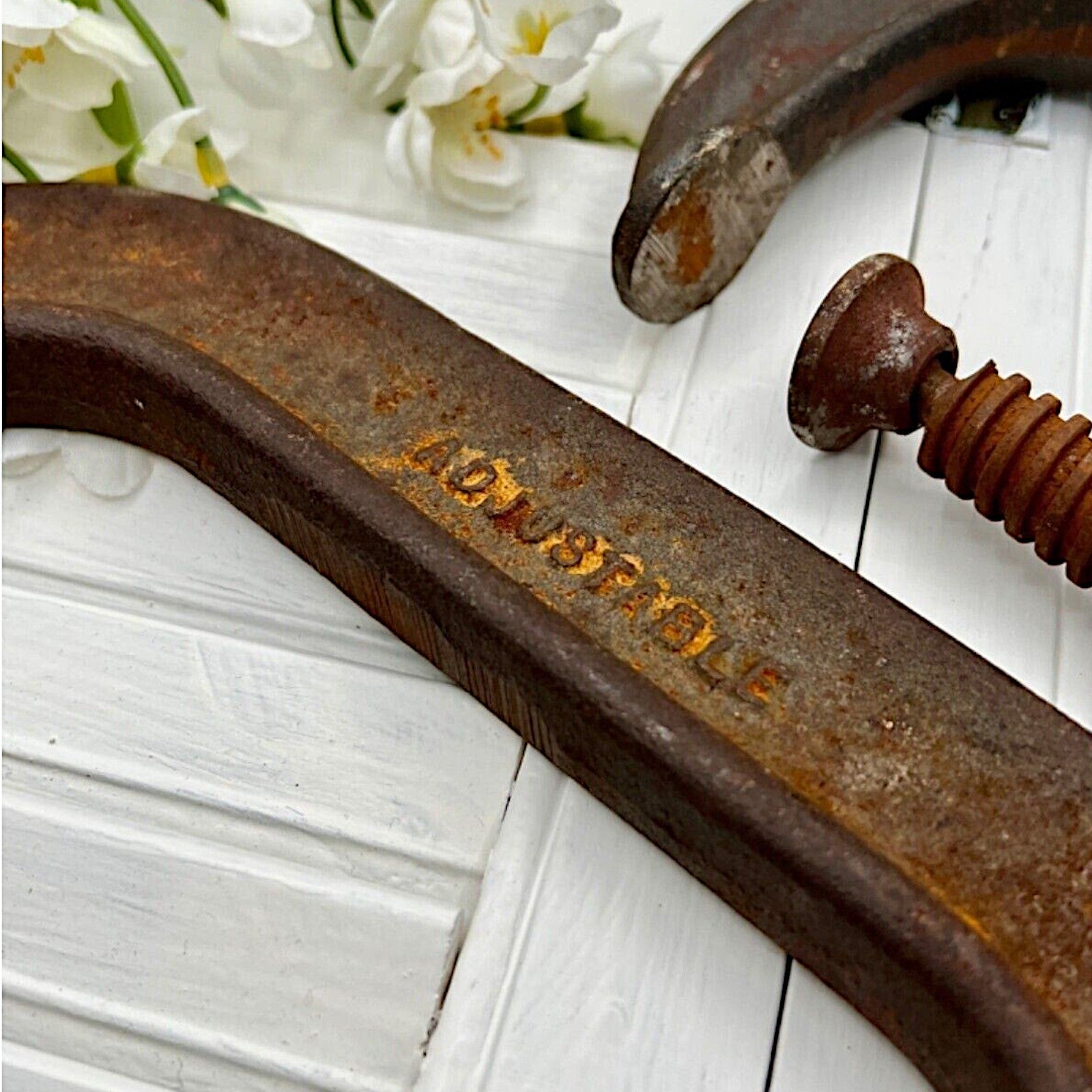 A pair of vintage industrial cast iron C-clamps by the Adjustable Clamp Co. displaying a rich rust brown patina on their heavy frames and steel screws. - Photo 6