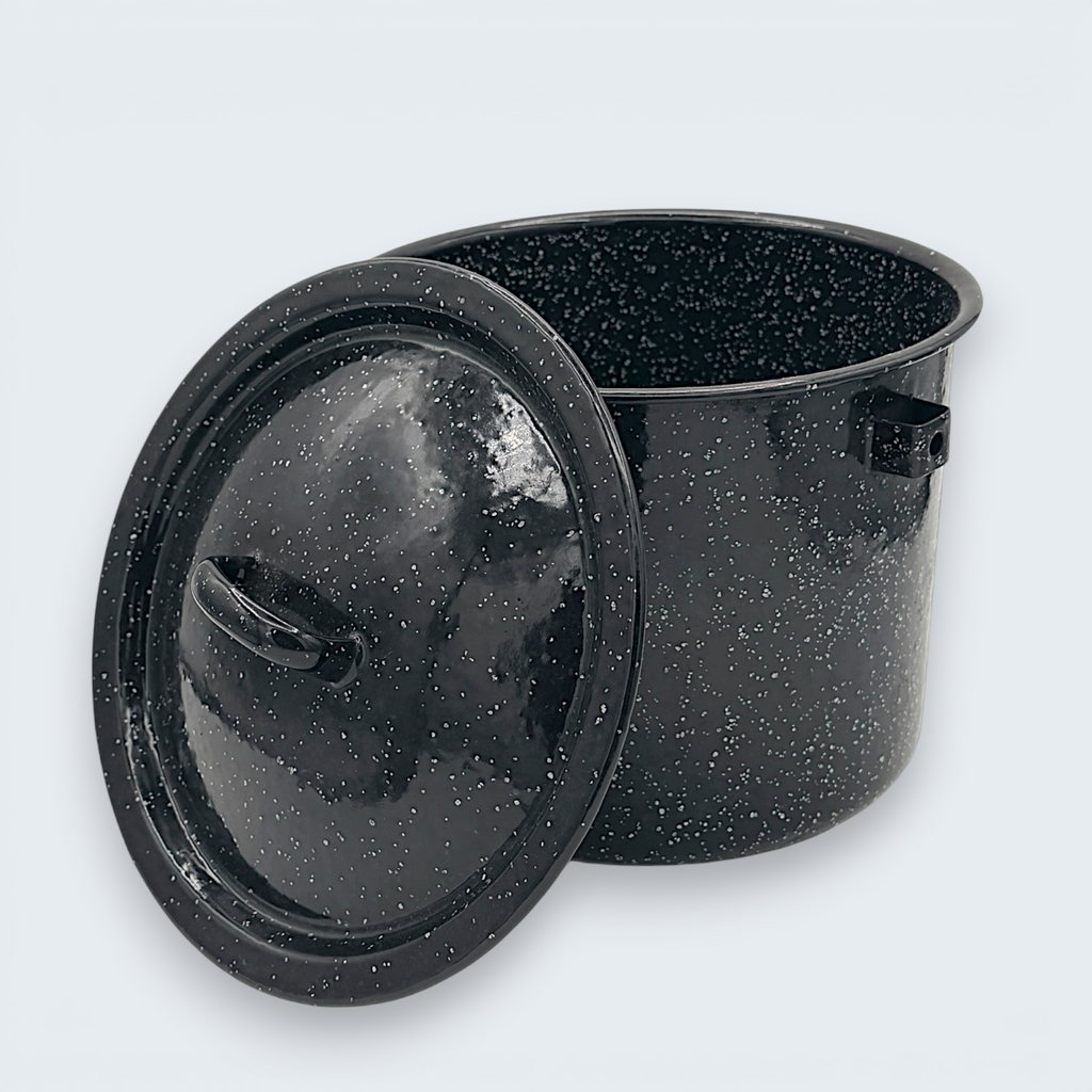 A vintage black speckled enamelware stock pot with a matching lid, featuring a classic white spatter pattern over a glossy black finish and sturdy handles. - Photo 1