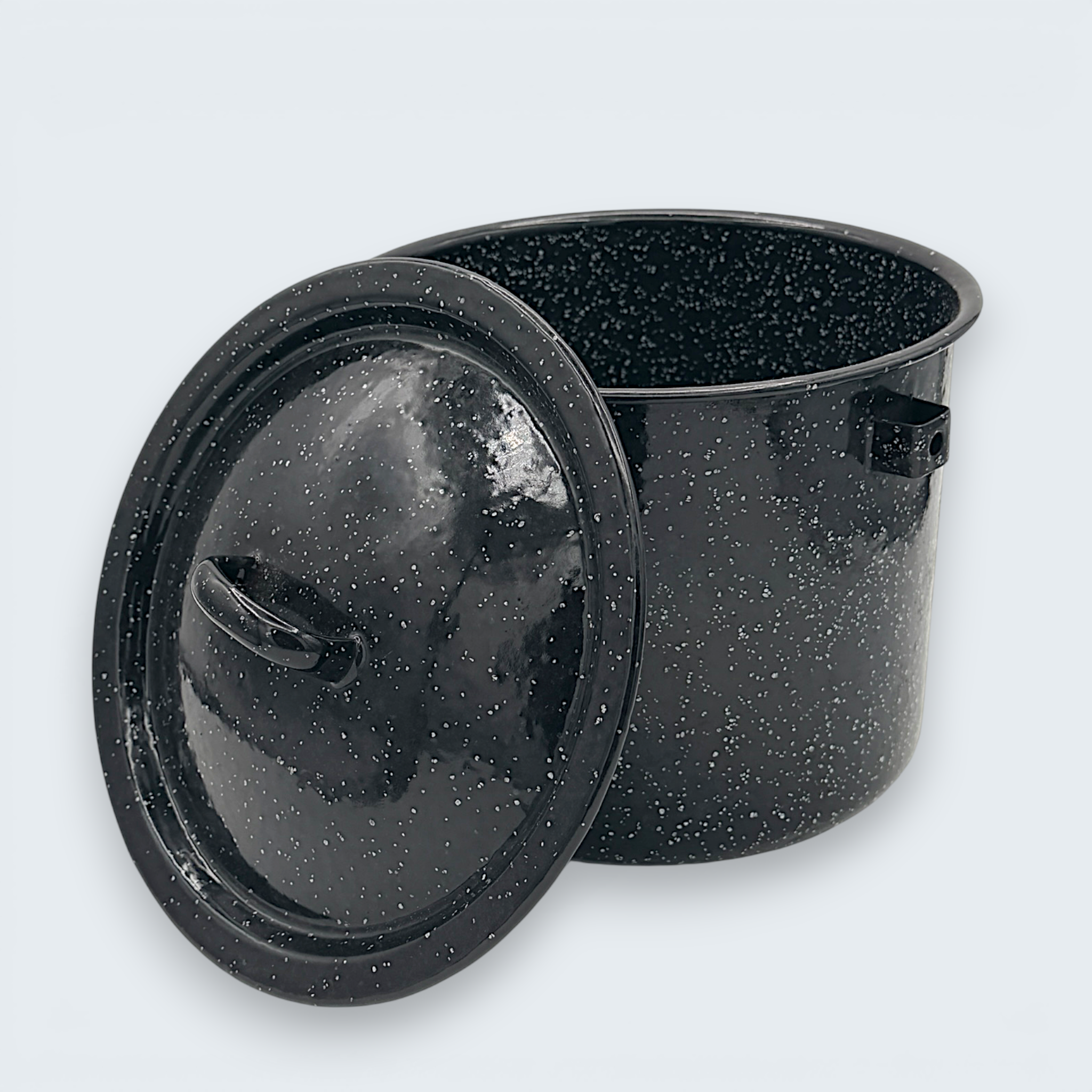 A vintage black speckled enamelware stock pot with a matching lid, featuring a classic white spatter pattern over a glossy black finish and sturdy handles. - Photo 1
