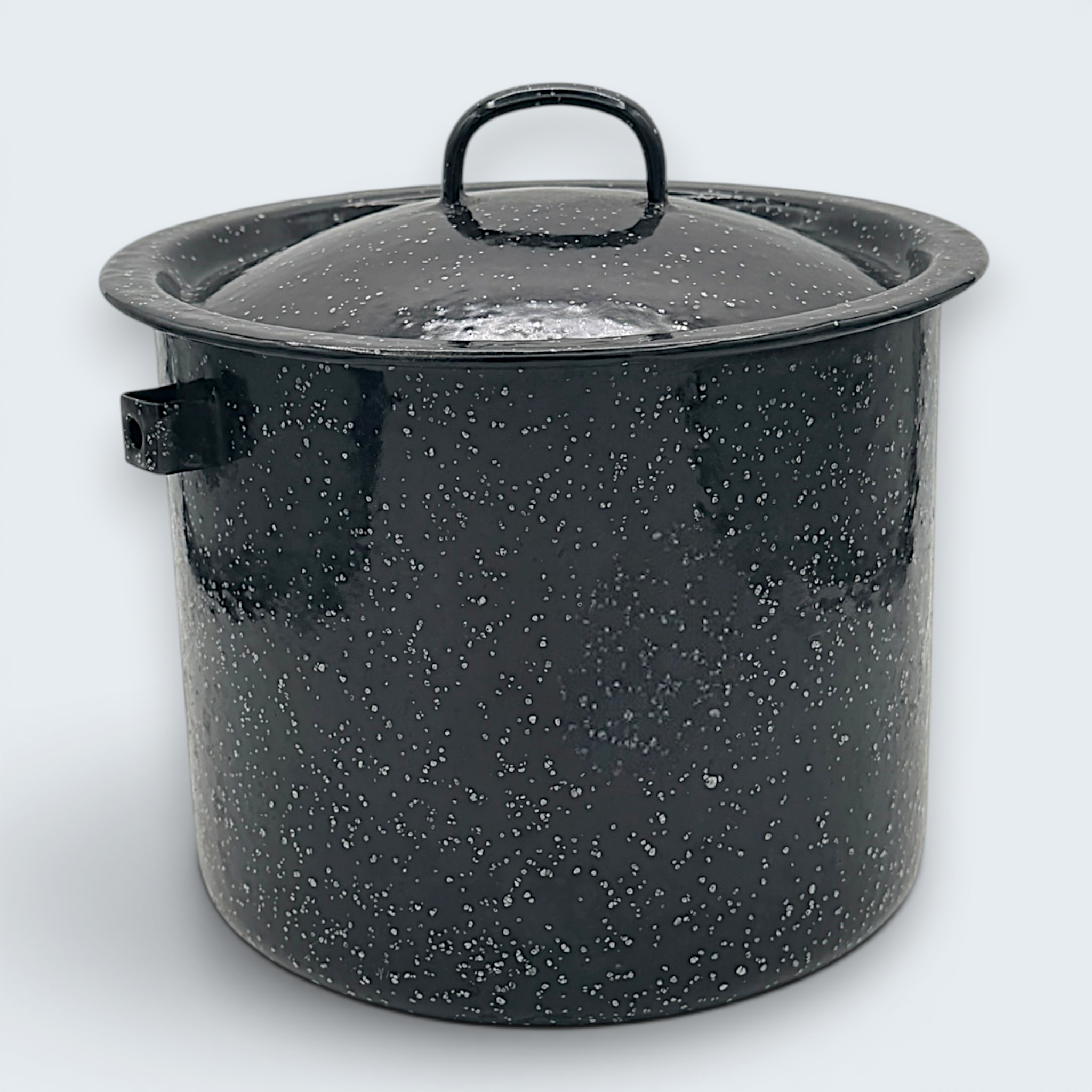 A vintage black speckled enamelware stock pot with a matching lid, featuring a classic white spatter pattern over a glossy black finish and sturdy handles. - Photo 2
