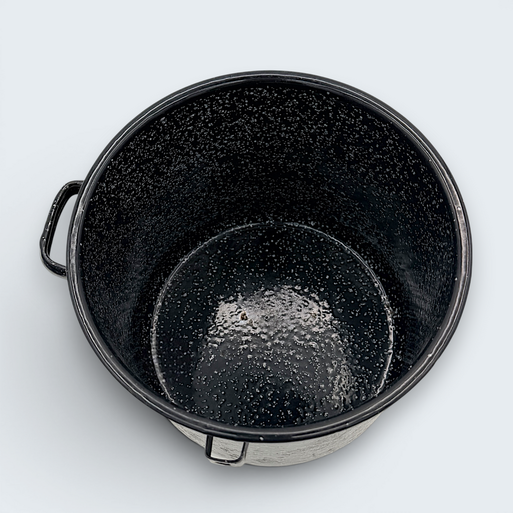 A vintage black speckled enamelware stock pot with a matching lid, featuring a classic white spatter pattern over a glossy black finish and sturdy handles. - Photo 4