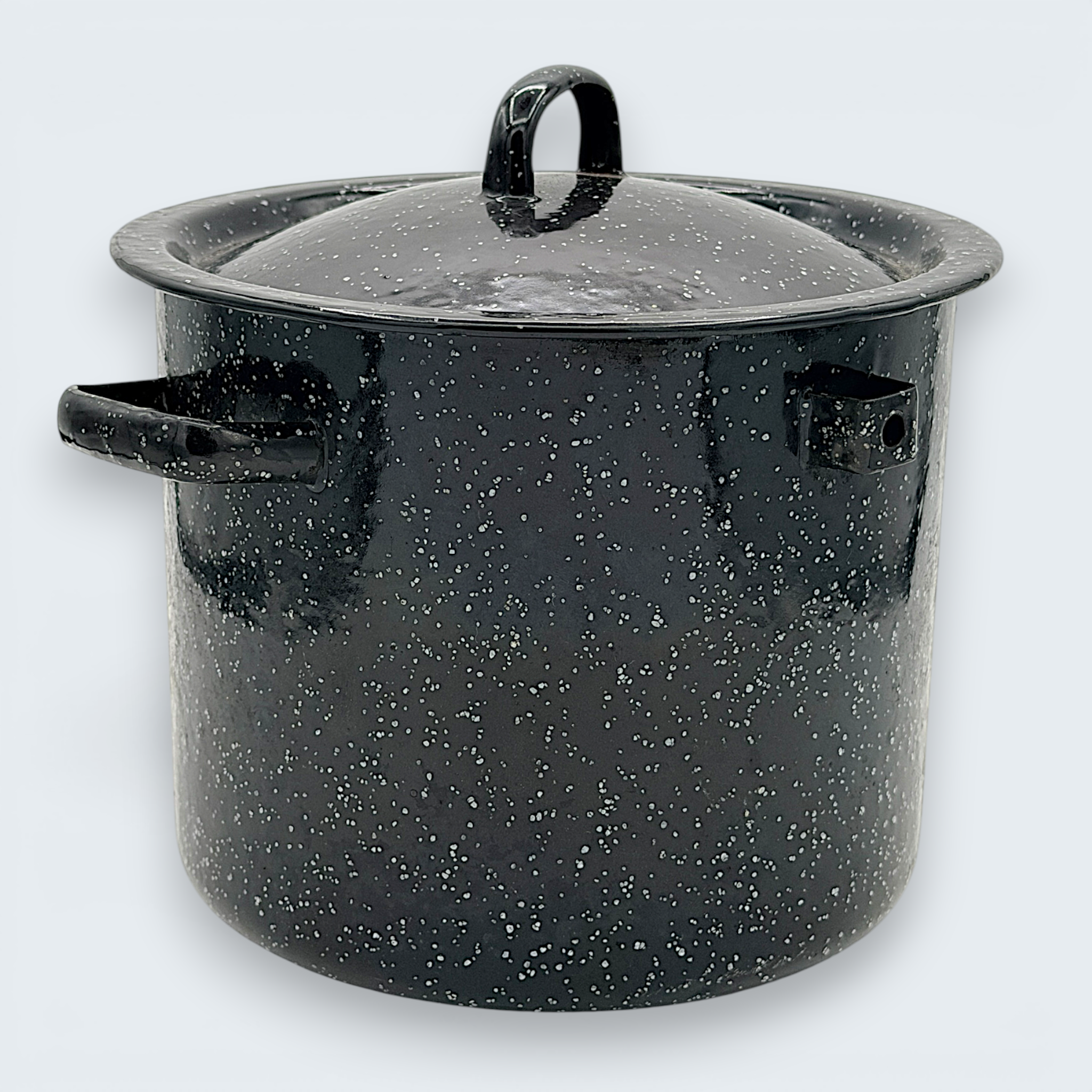 A vintage black speckled enamelware stock pot with a matching lid, featuring a classic white spatter pattern over a glossy black finish and sturdy handles. - Photo 5